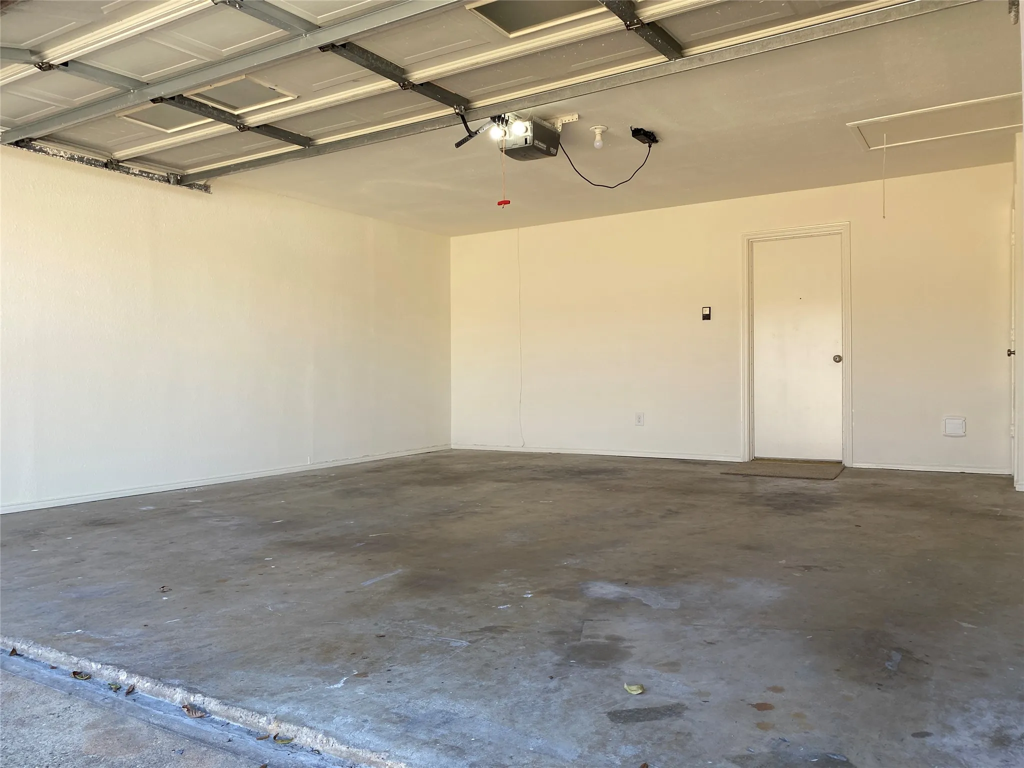 Fresh paint in the interior of the garage with door opener and two controls.