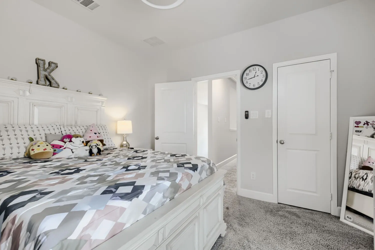 Plush grey carpeting and light grey wall paint