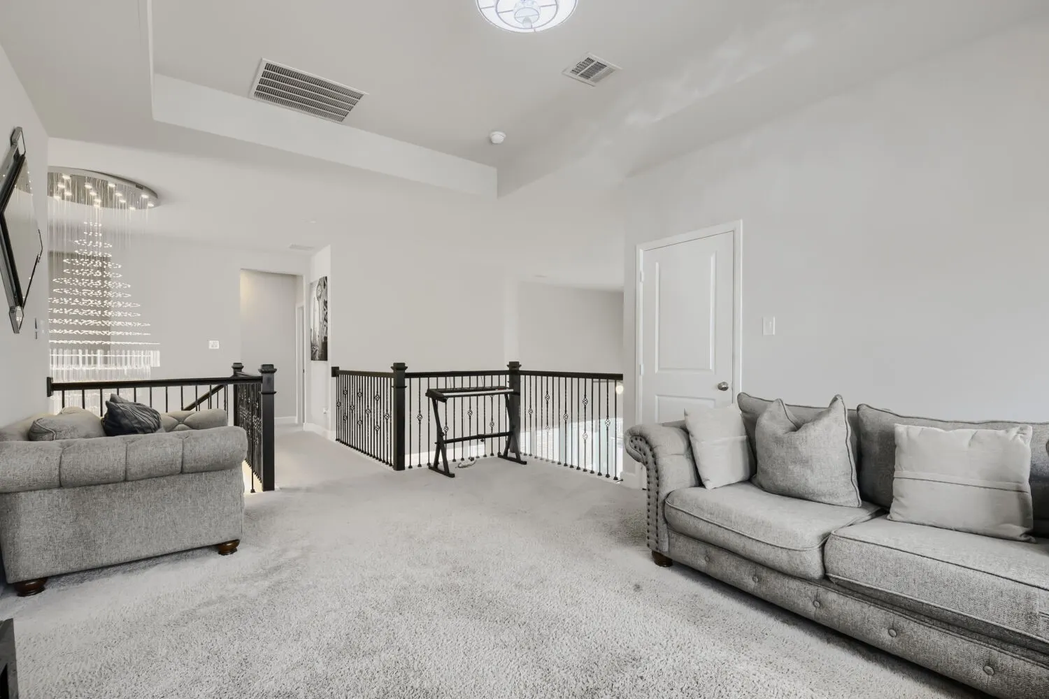 Loft space featuring light gray carpeting and white walls