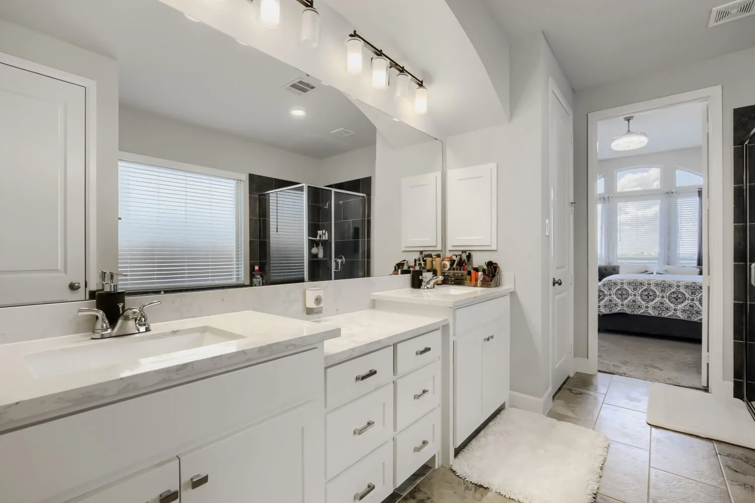 Dual vanities featuring undermount sinks and light-colored countertops