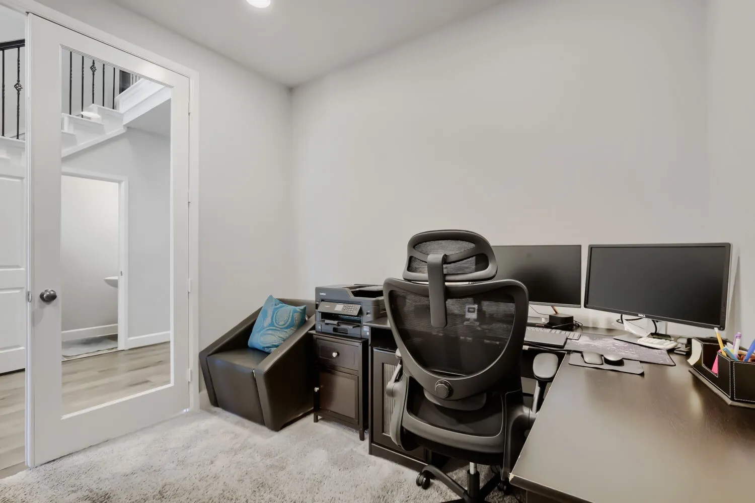 Recessed ceiling lighting, white painted walls, and light-toned carpet flooring