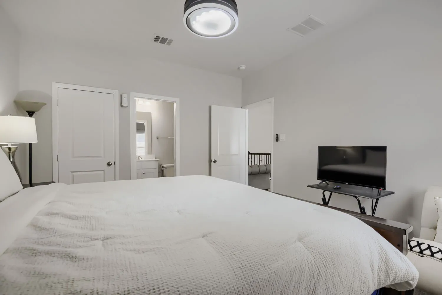 Recessed ceiling lighting, white interior doors, and light gray wall paint