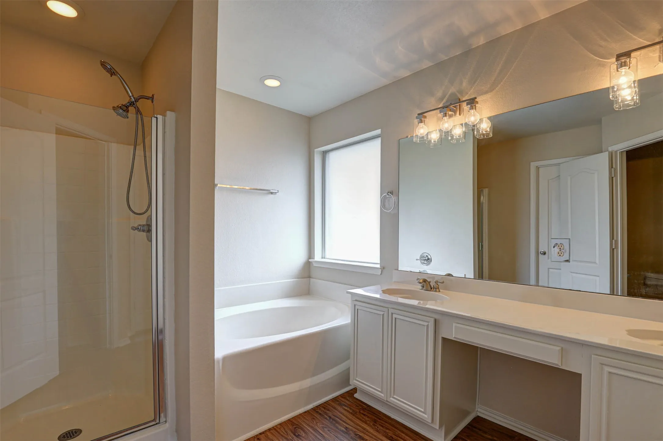 Dual sinks and sitting area for glam time in the master bathroom