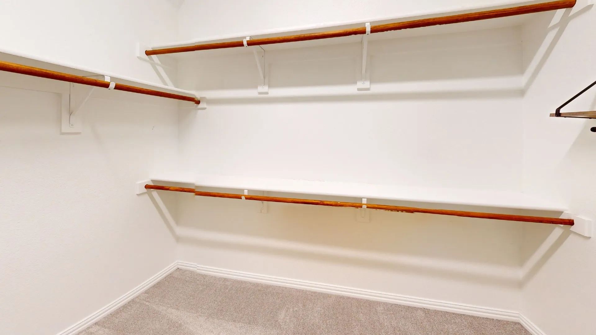 Built-in shelving and closet rods provide organized storage