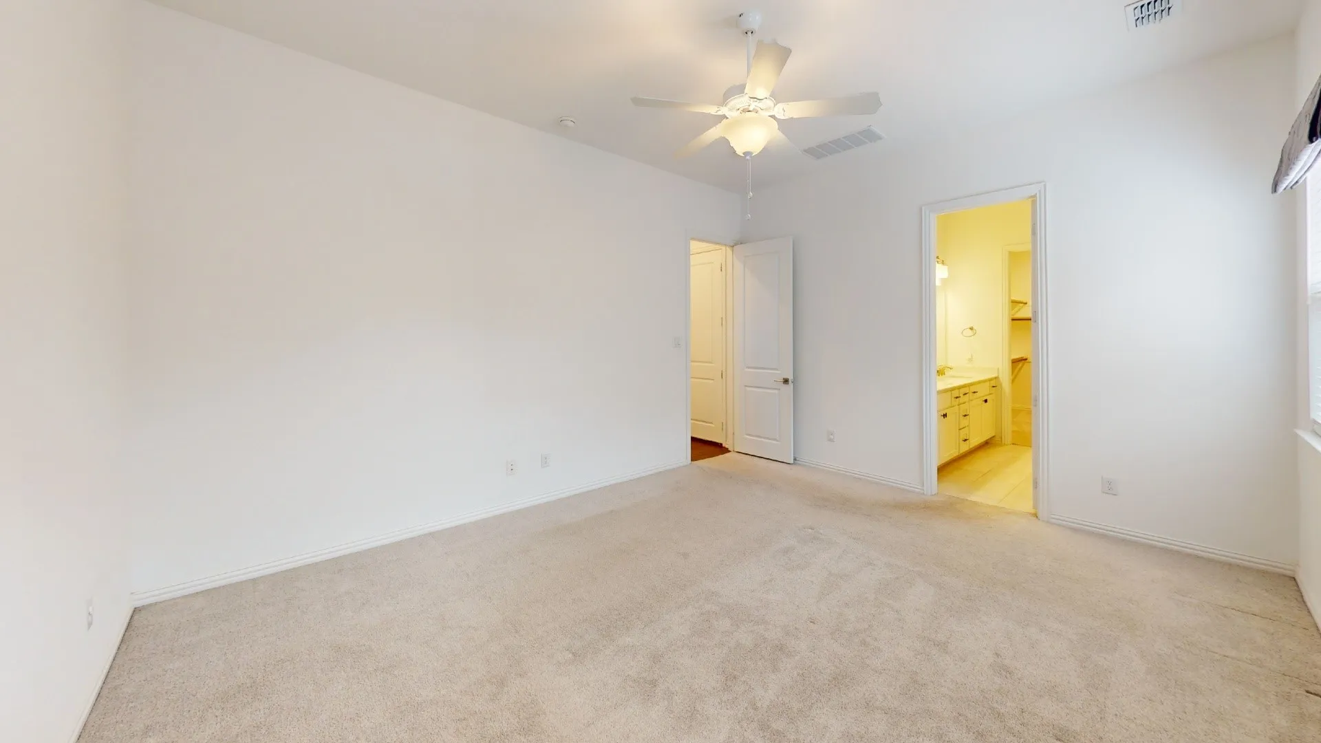 Carpeted flooring, ceiling fan, white paneled doors, and bright interior lighting