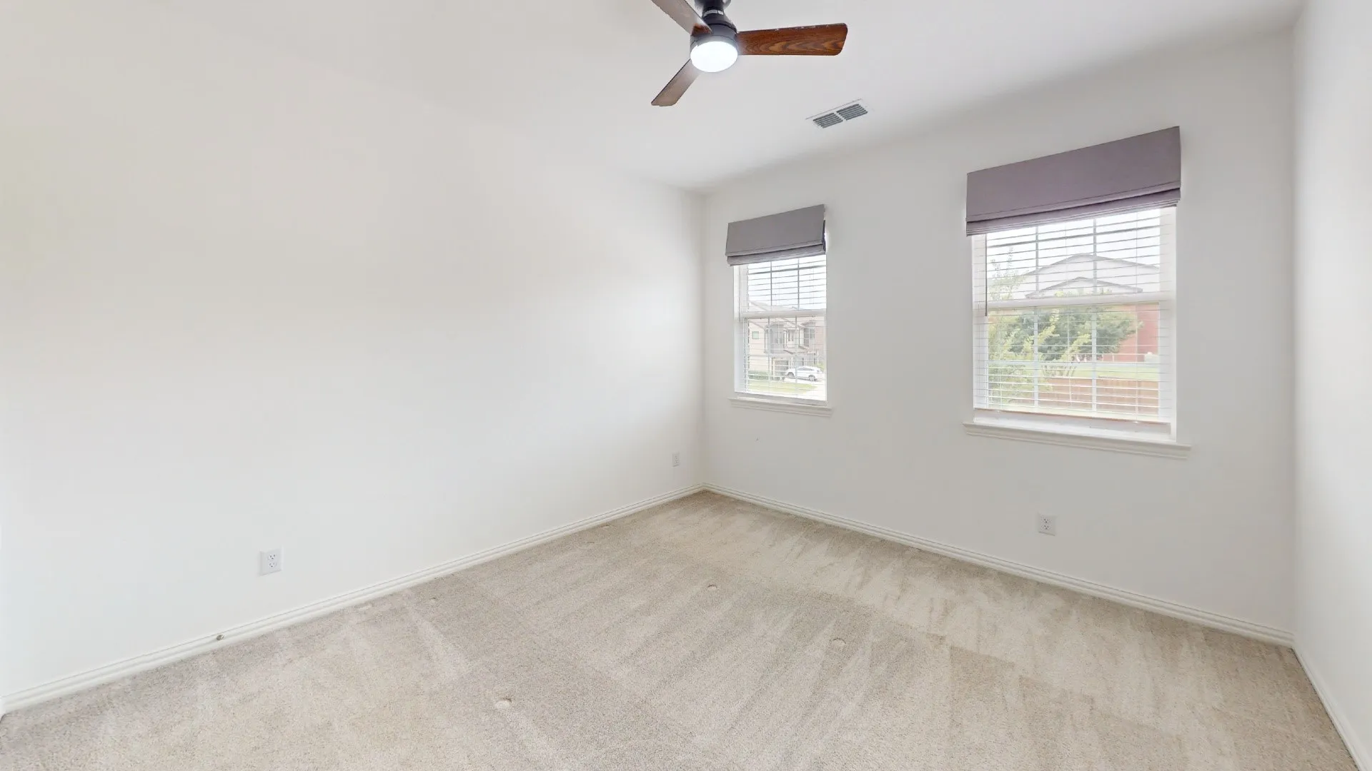Wall-to-wall carpeting, two windows with blinds, ceiling fan with light fixture