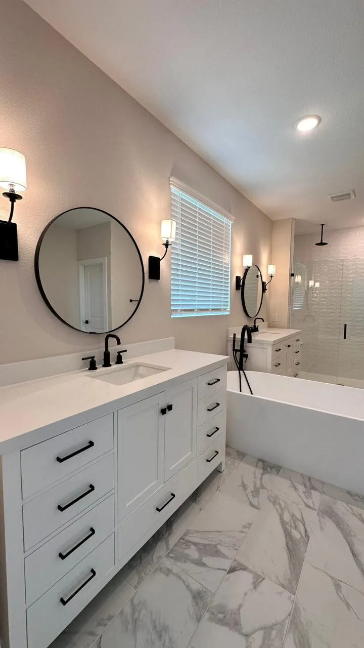 Double vanity with white cabinetry and matte black hardware