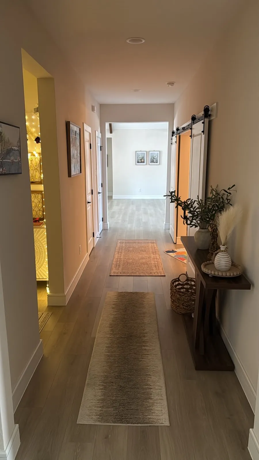 Recessed lighting, wood-finish flooring, white baseboards, and a barn door entry