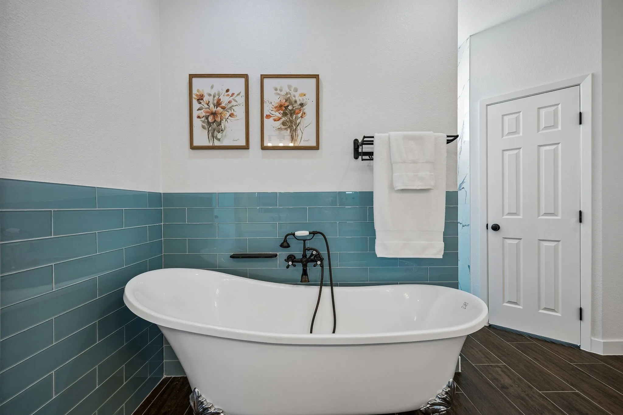 Soak in this charming freestanding tub with designer inspired tile finishes
