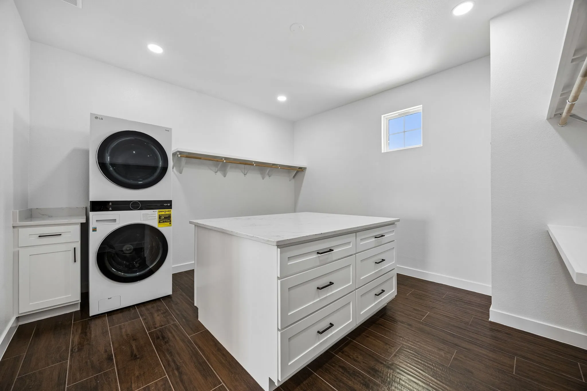 Primary walk-in closet with stackable washer and dryer. So convenient!