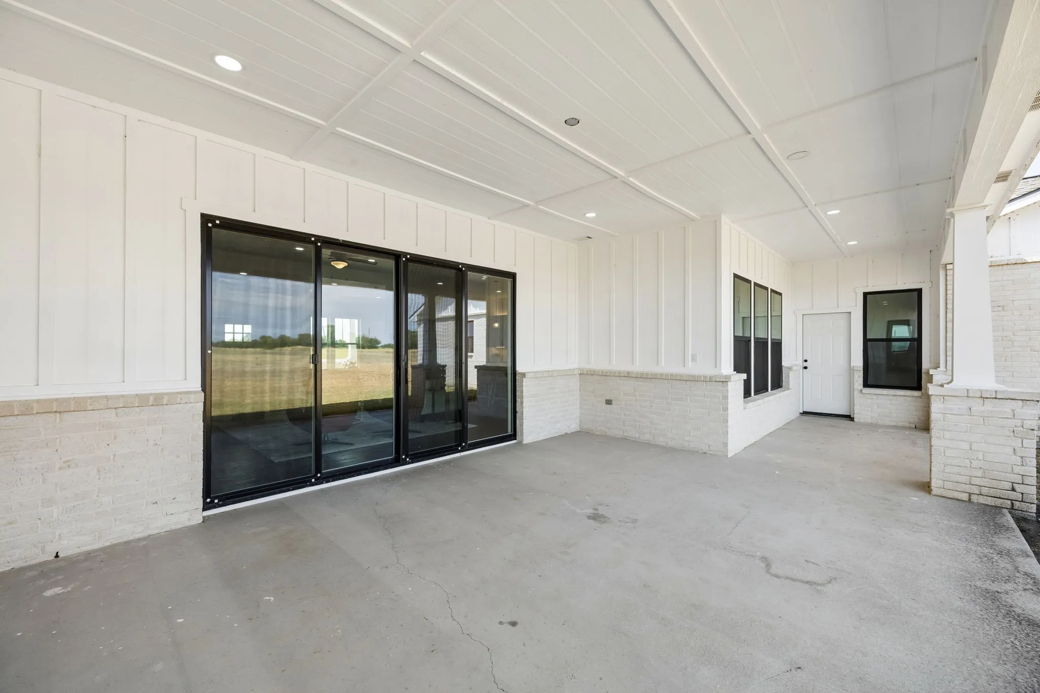 Extended covered patio with sliding glass doors