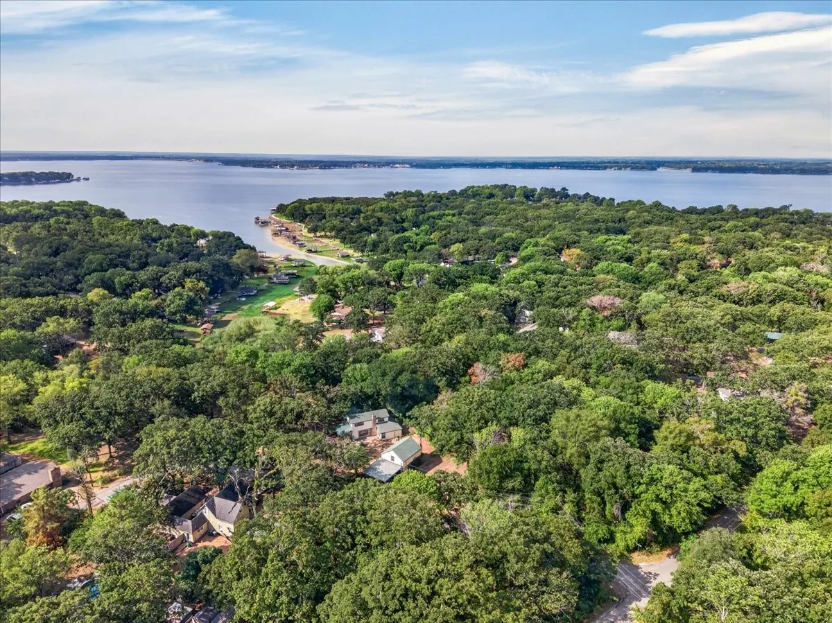 Expansive waterfront property featuring a natural treed landscape