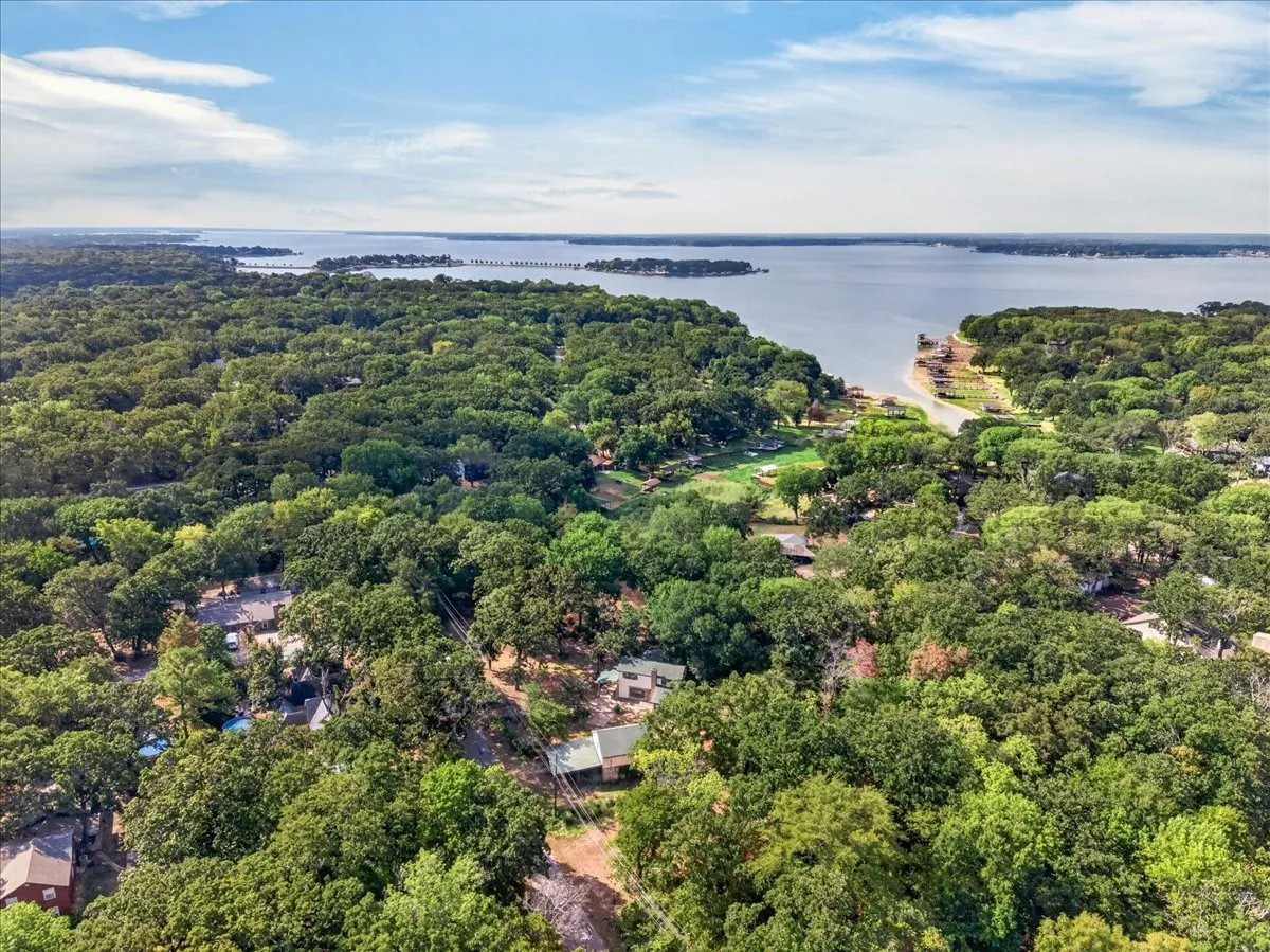 Expansive wooded landscape with waterfront access and scattered residential structures