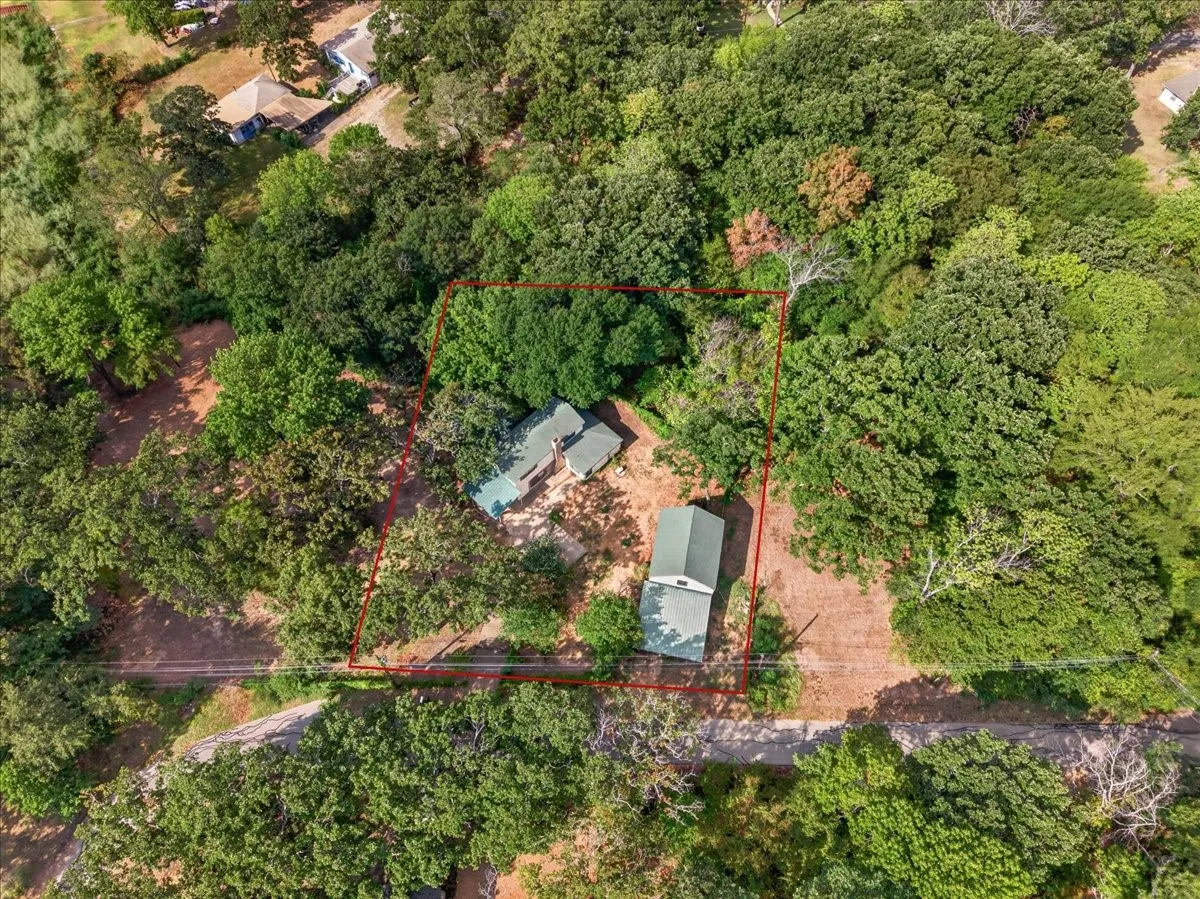Expansive wooded property with a main residence and an additional outbuilding