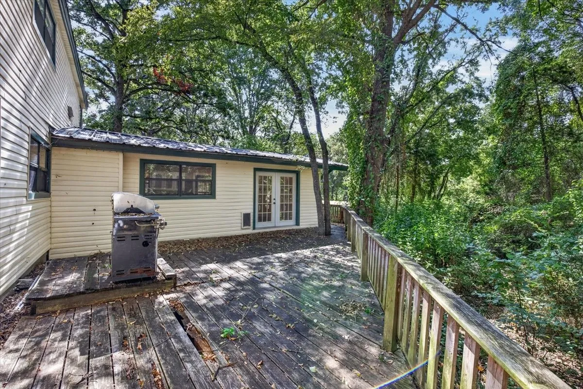 Exterior siding and a wood deck with a railing