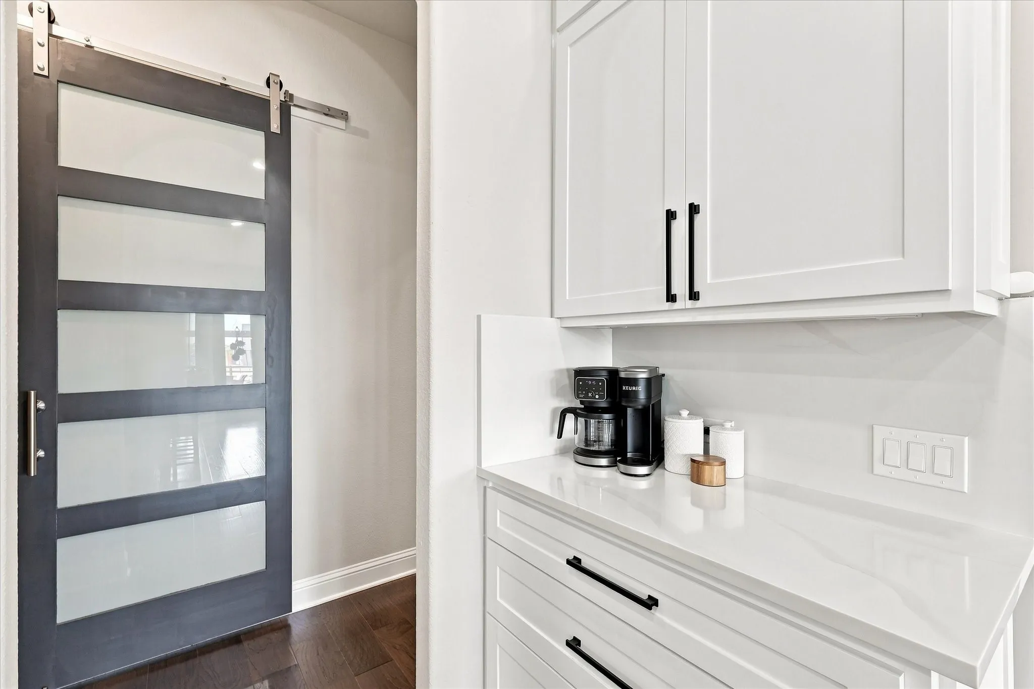 Coffee bar and pantry with sliding door.