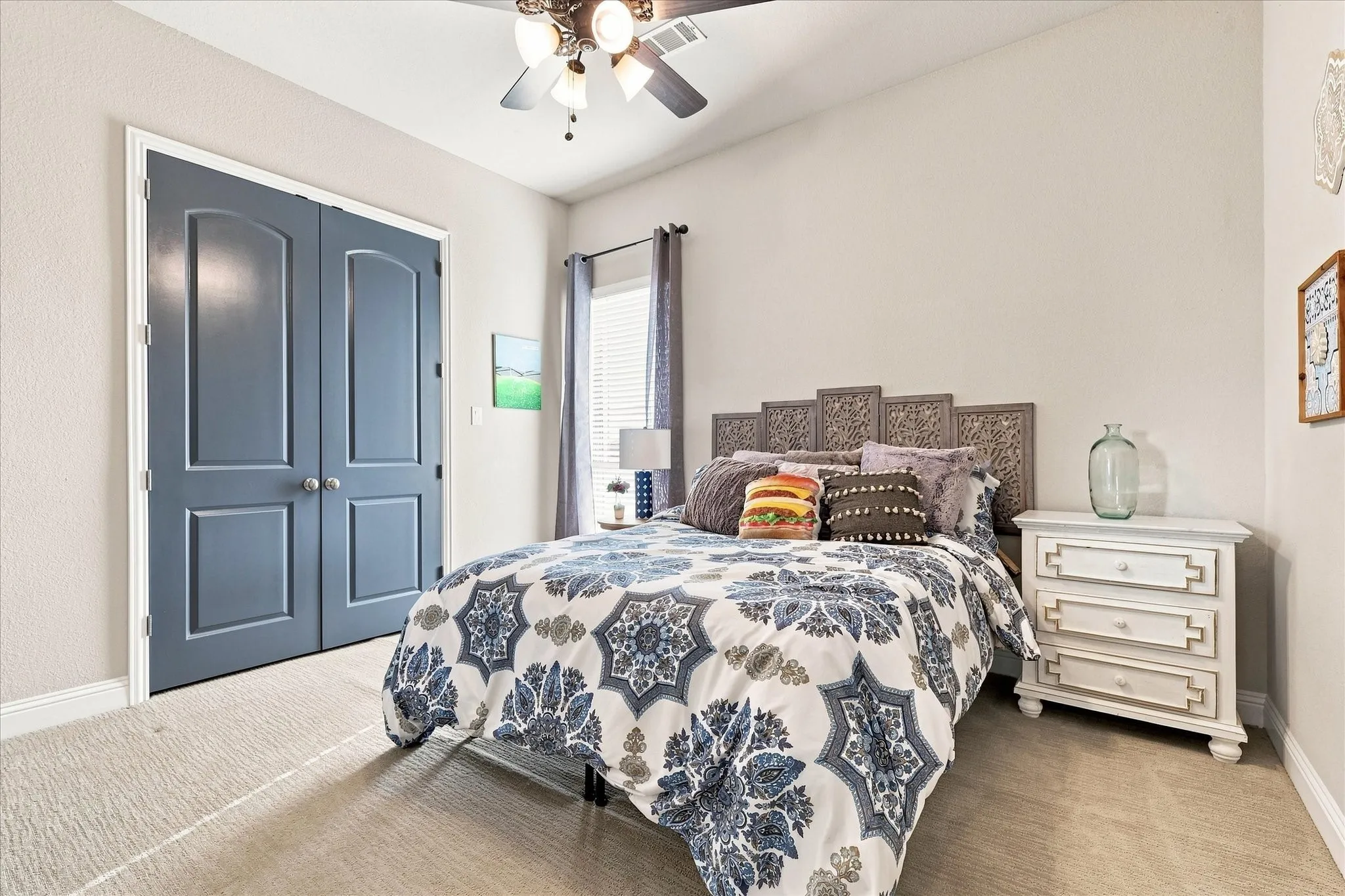 Carpeted flooring, vaulted ceiling, ceiling fan with integrated lighting, and a window with blinds
