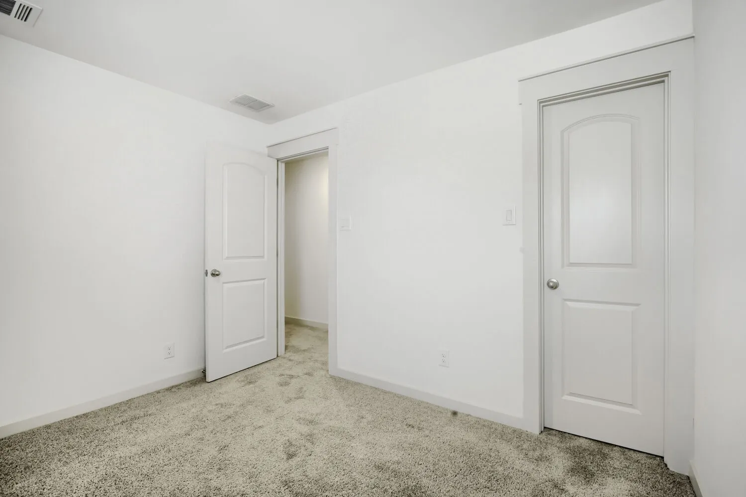 Plush carpeted flooring, white walls, and white trim