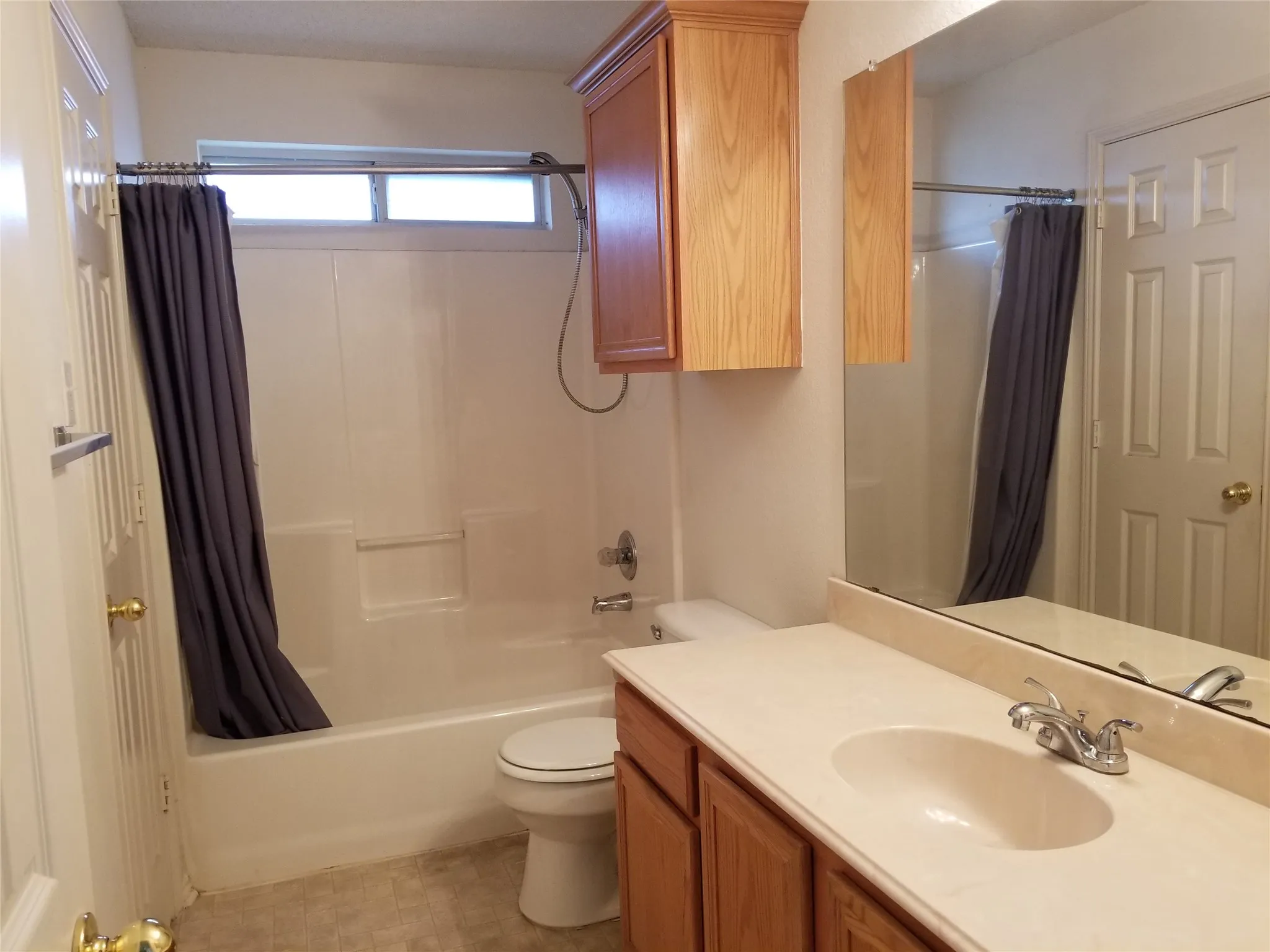 White single-piece bathtub and shower combination with a window