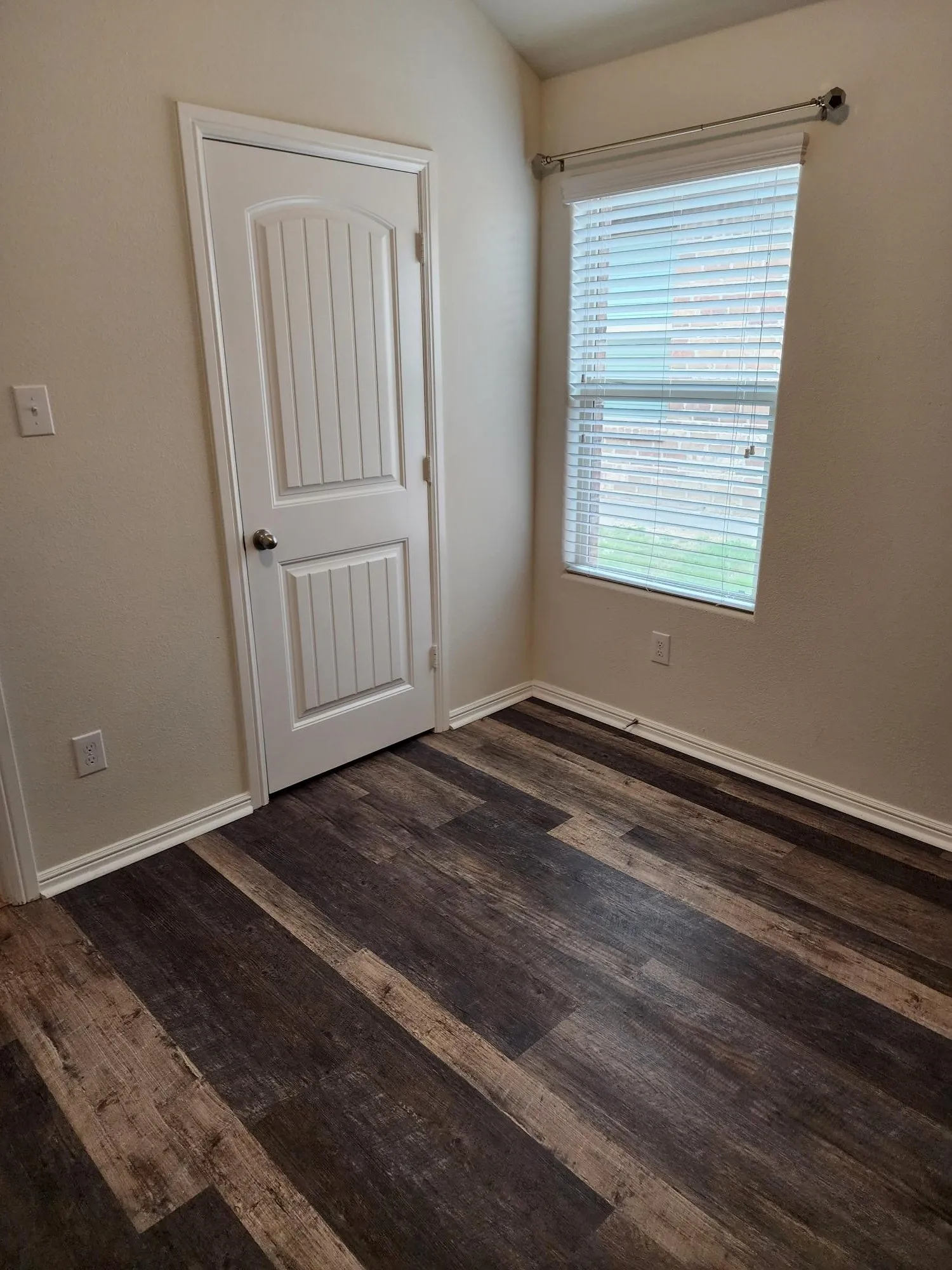 Unfurnished room with dark wood-type flooring