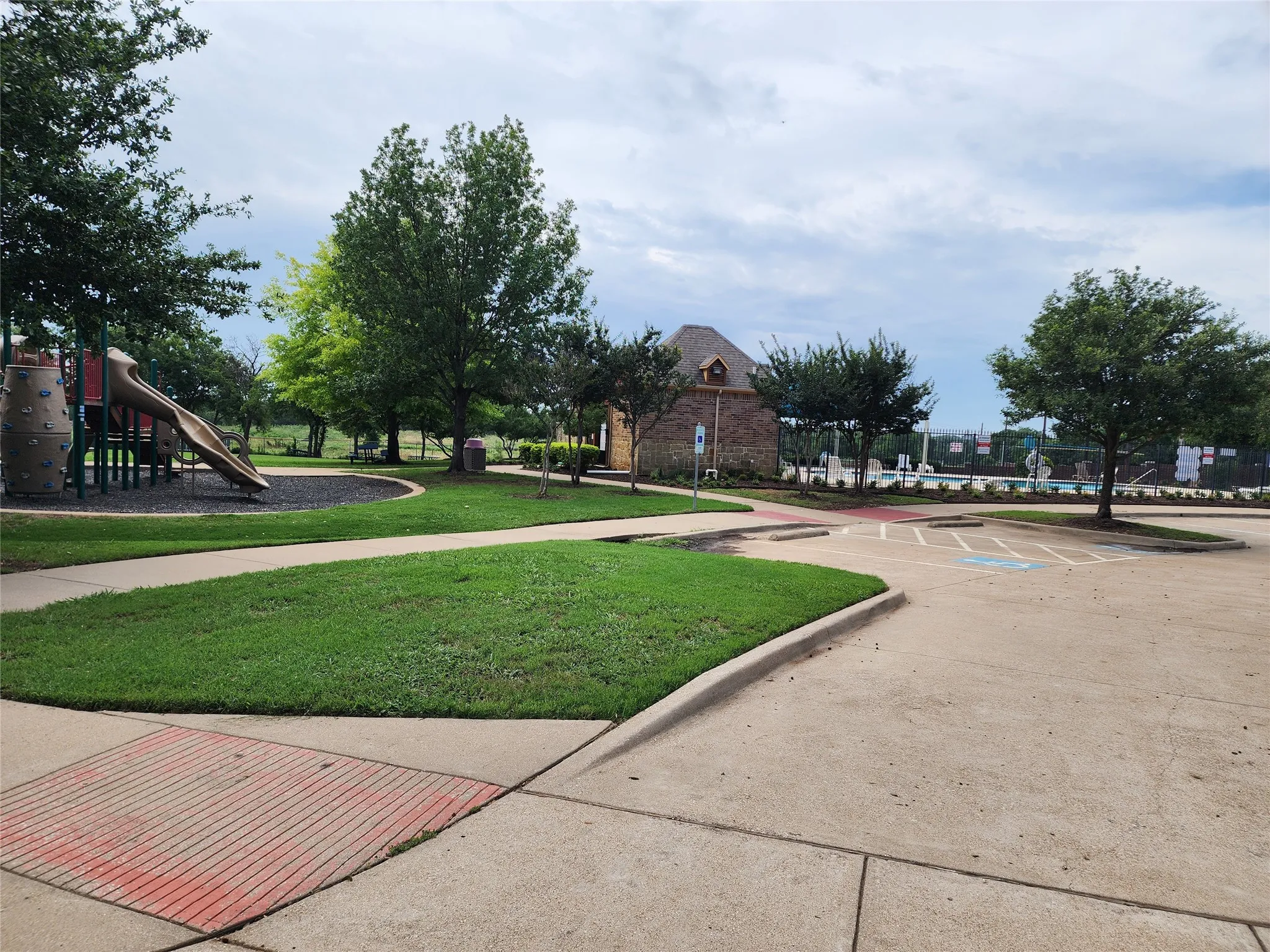 View of home's community with a playground and a lawn
