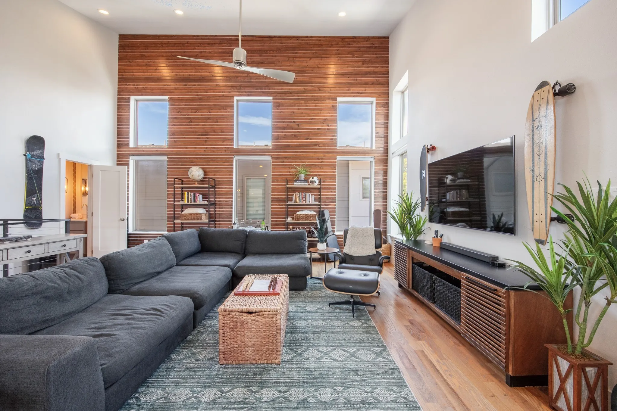 Tall cedar wall anchors the living room