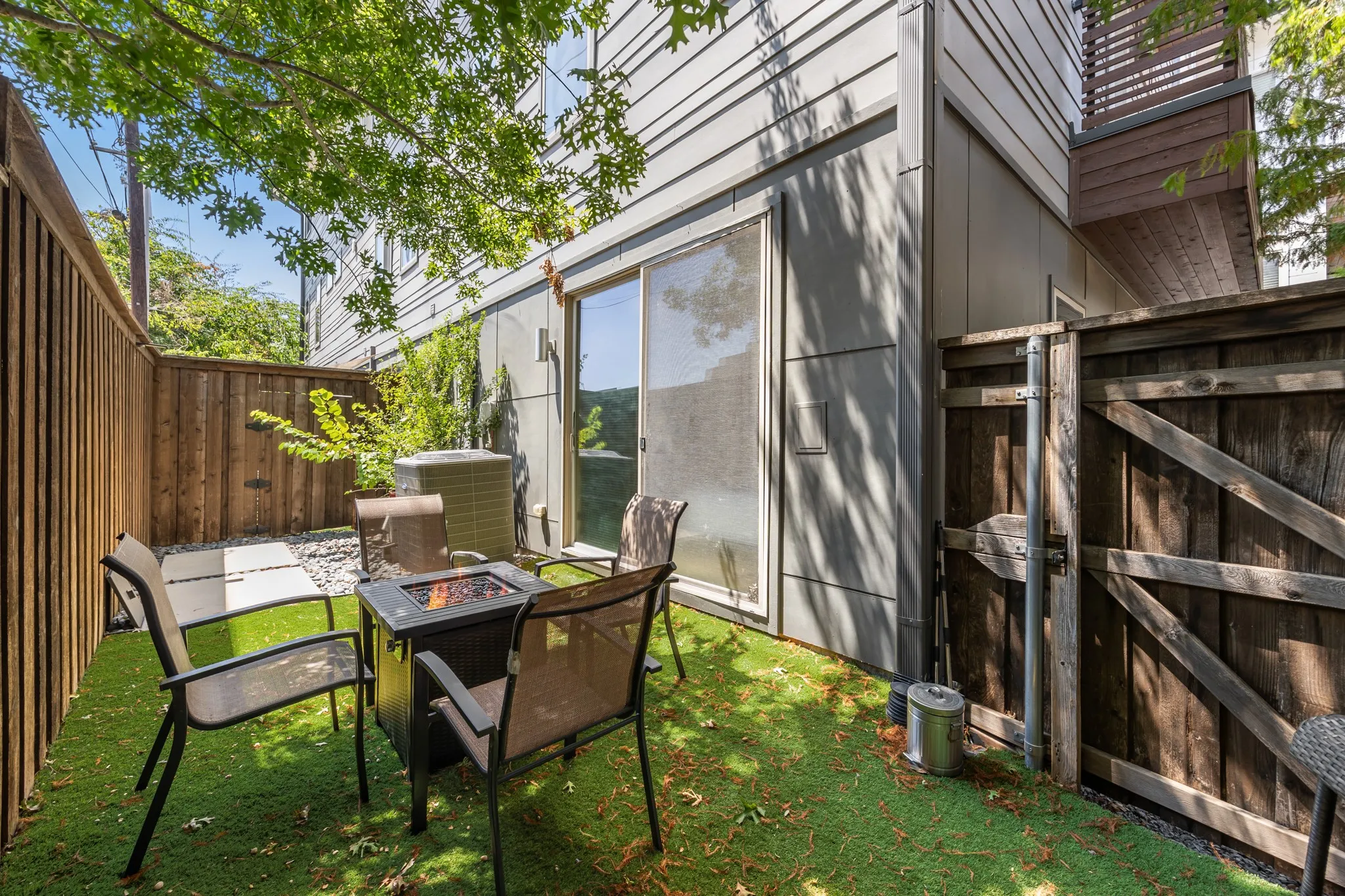 Fenced patio with gate to the drive
