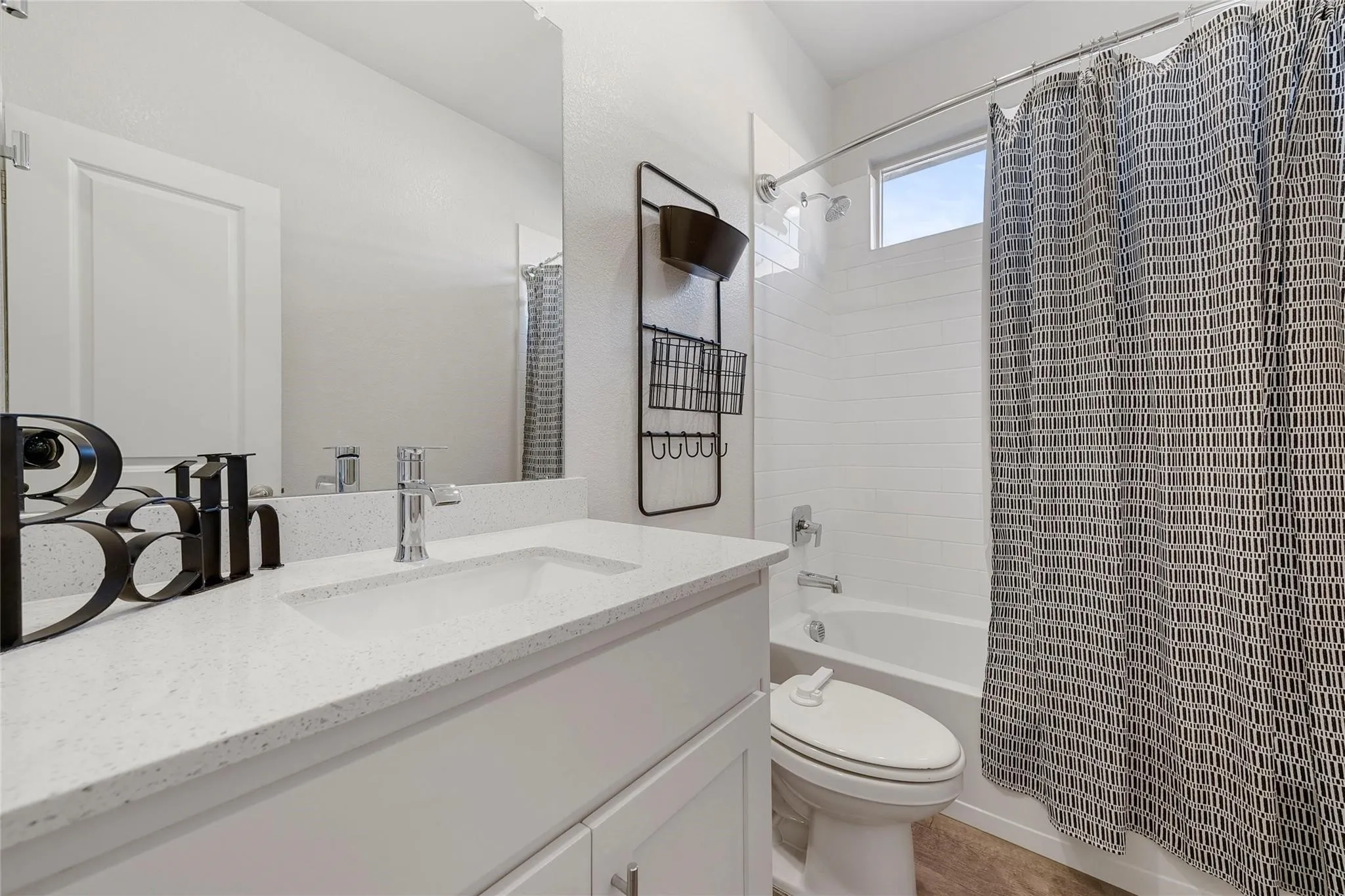 Full bathroom with shower / bath combo with shower curtain, vanity, and toilet