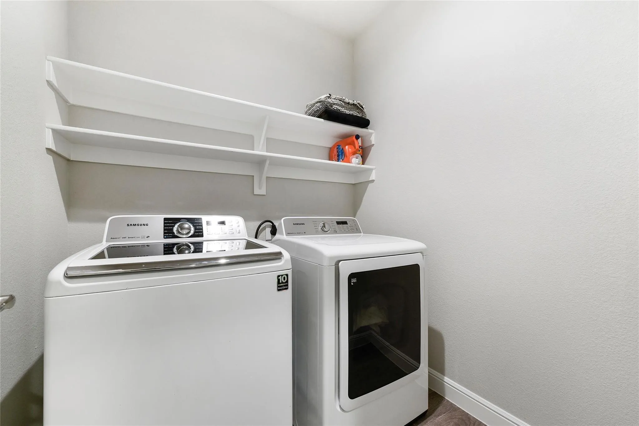 Laundry room featuring independent washer and dryer and wood-type flooring