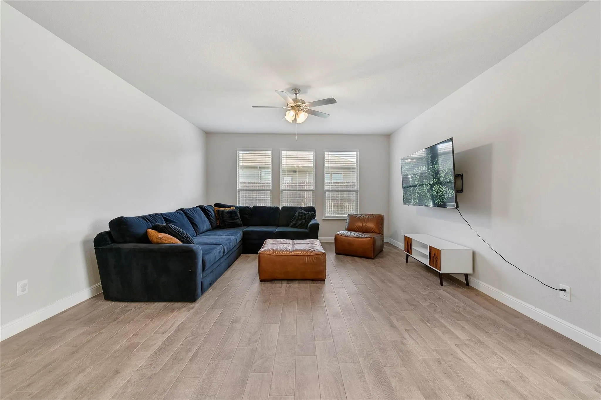Living room featuring light hardwood / wood-style flooring and ceiling fan