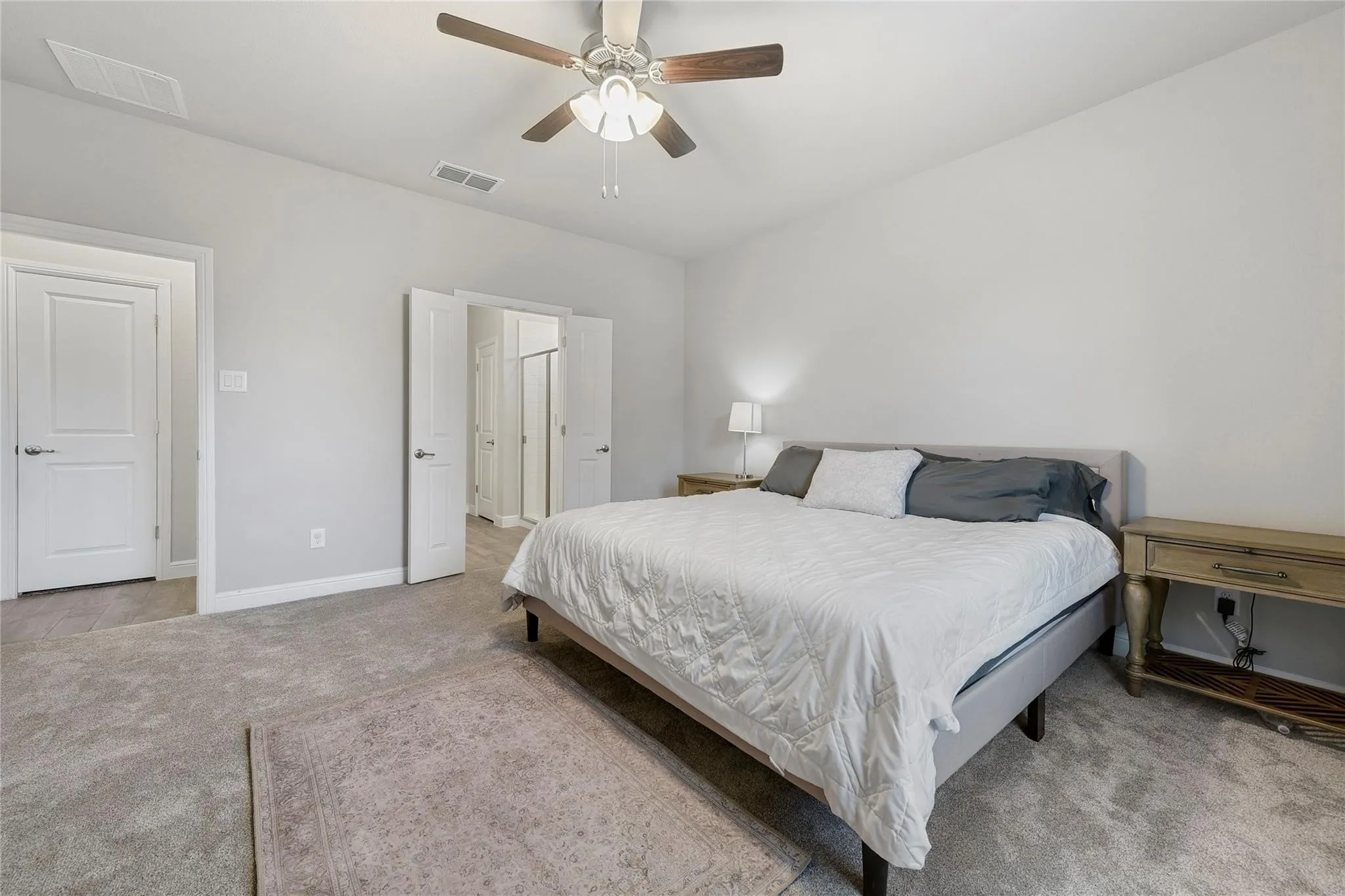 Bedroom with light carpet and ceiling fan
