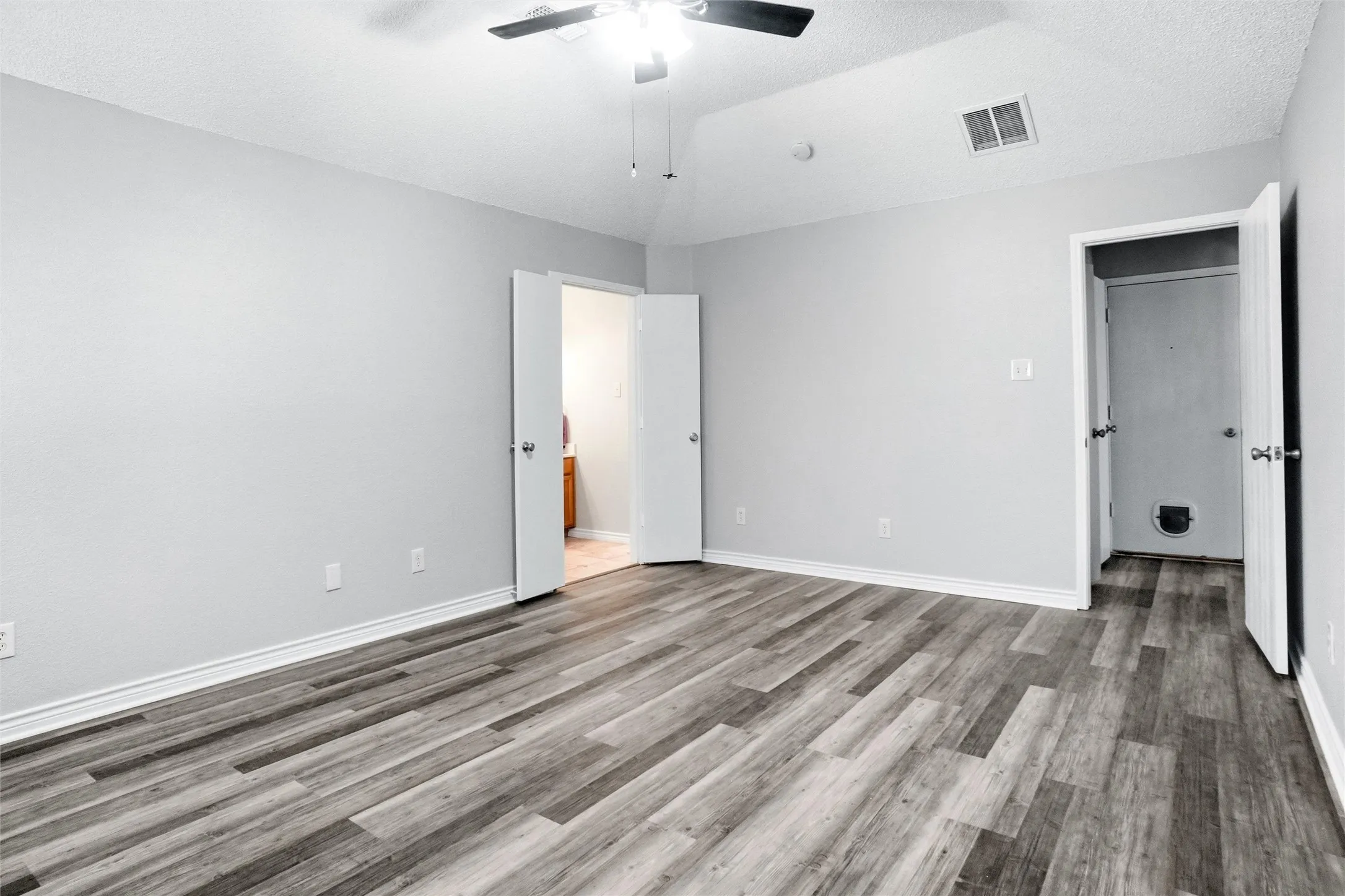 luxury vinyl plank flooring throughout, complemented by a ceiling fan with integrated lighting