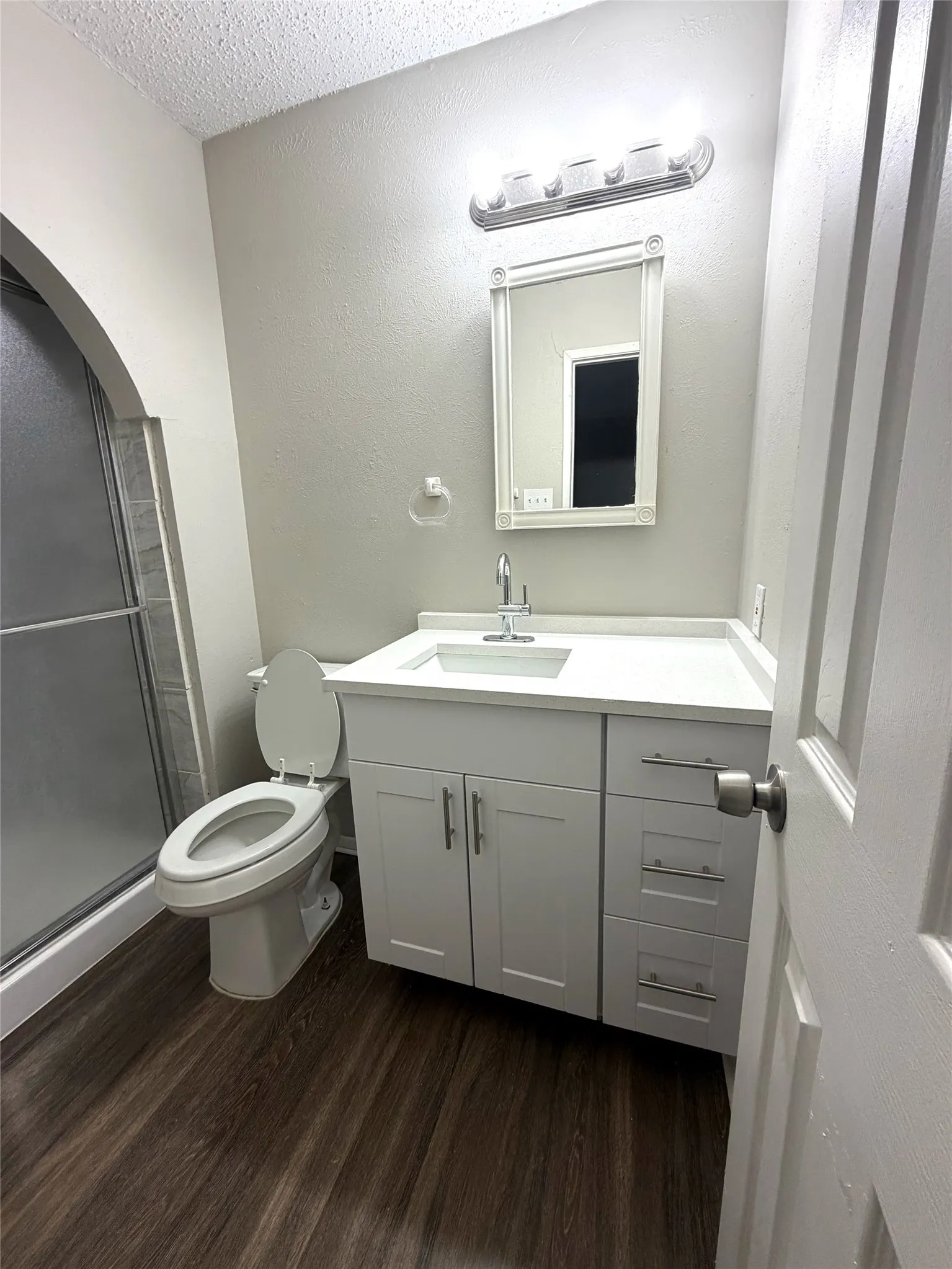White shaker-style vanity with integrated sink and chrome fixtures