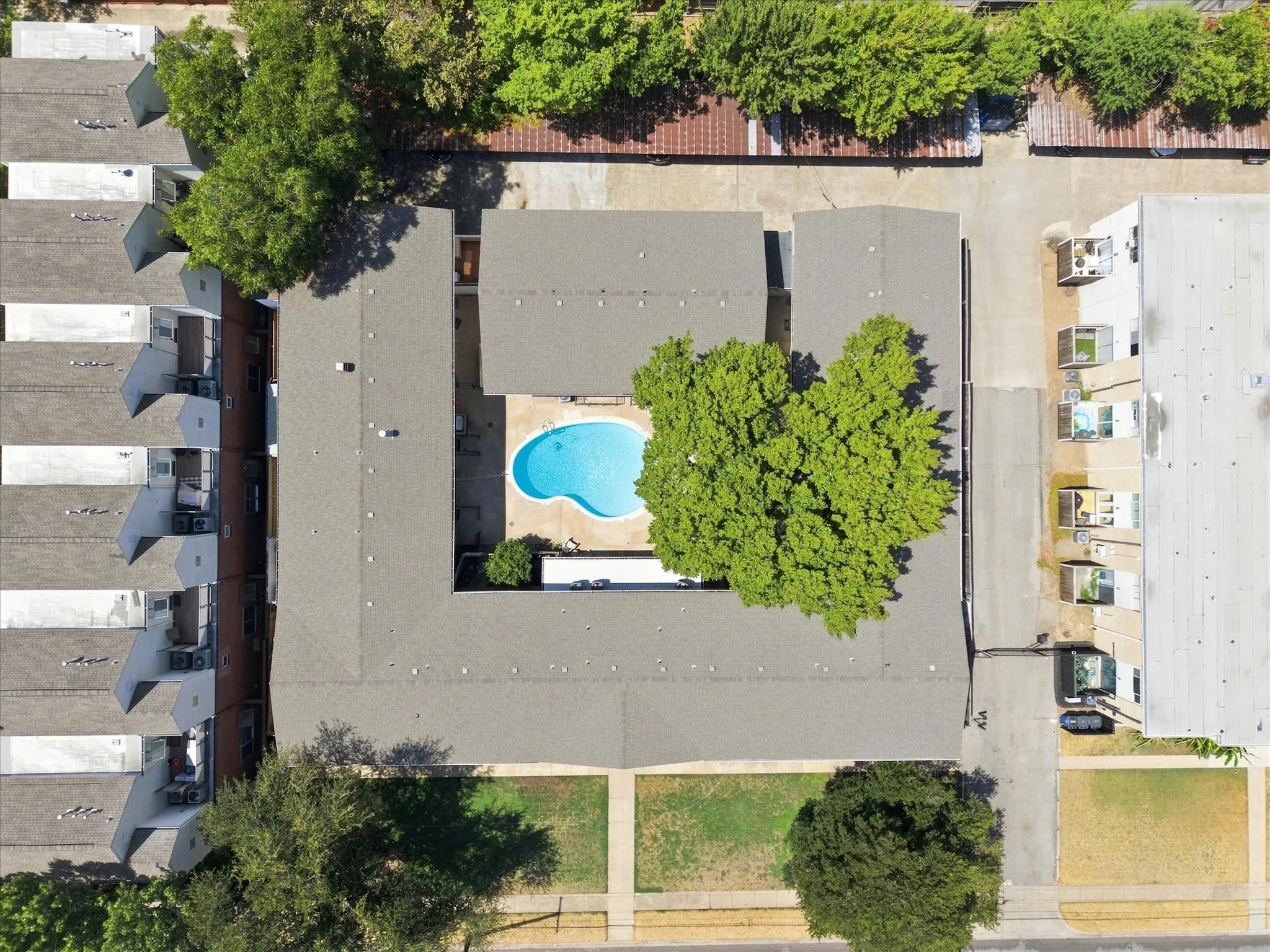 Aerial view of central courtyard featuring a kidney-shaped swimming pool.