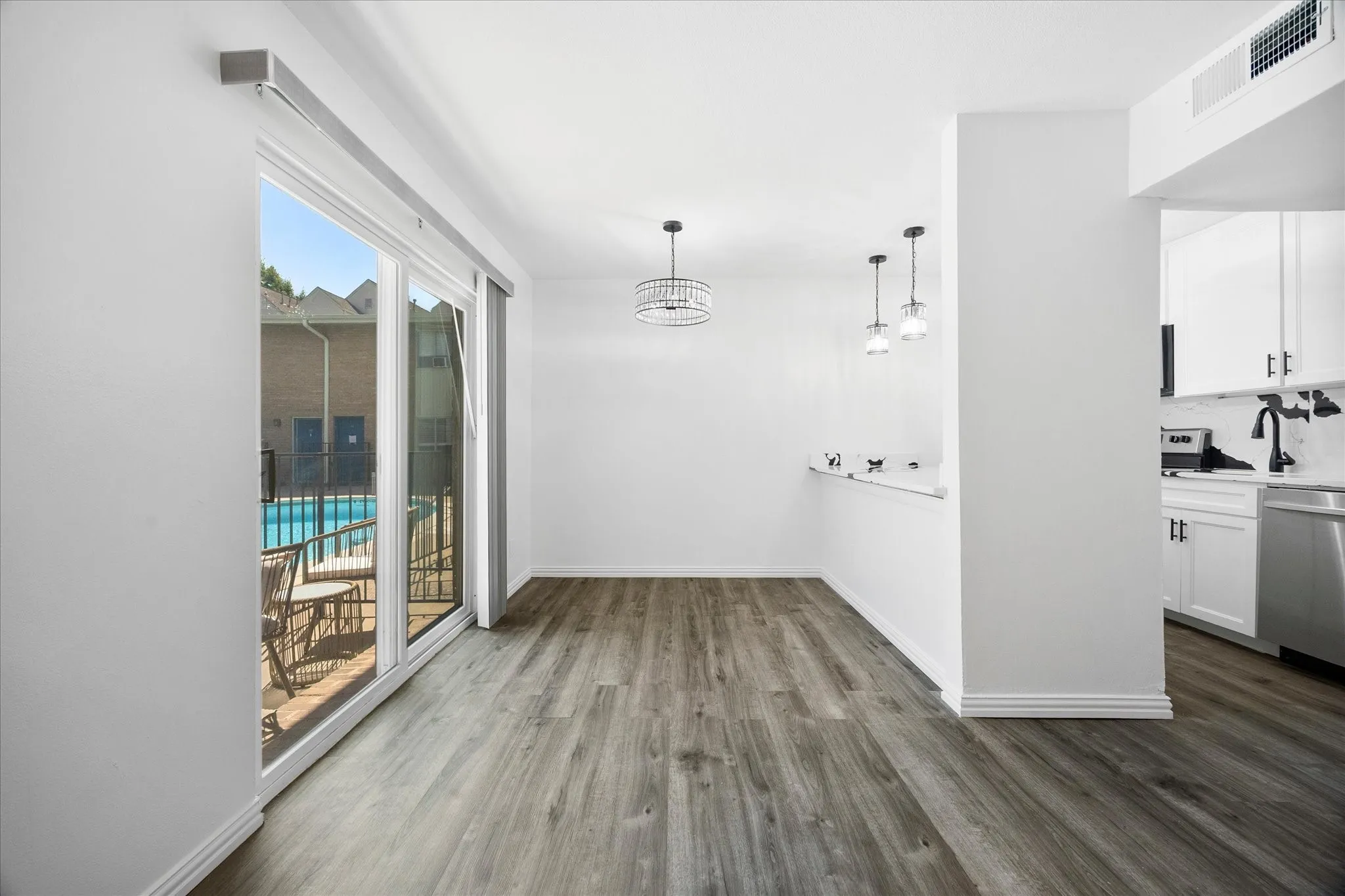 Original dining area overlooking the community pool and courtyard.