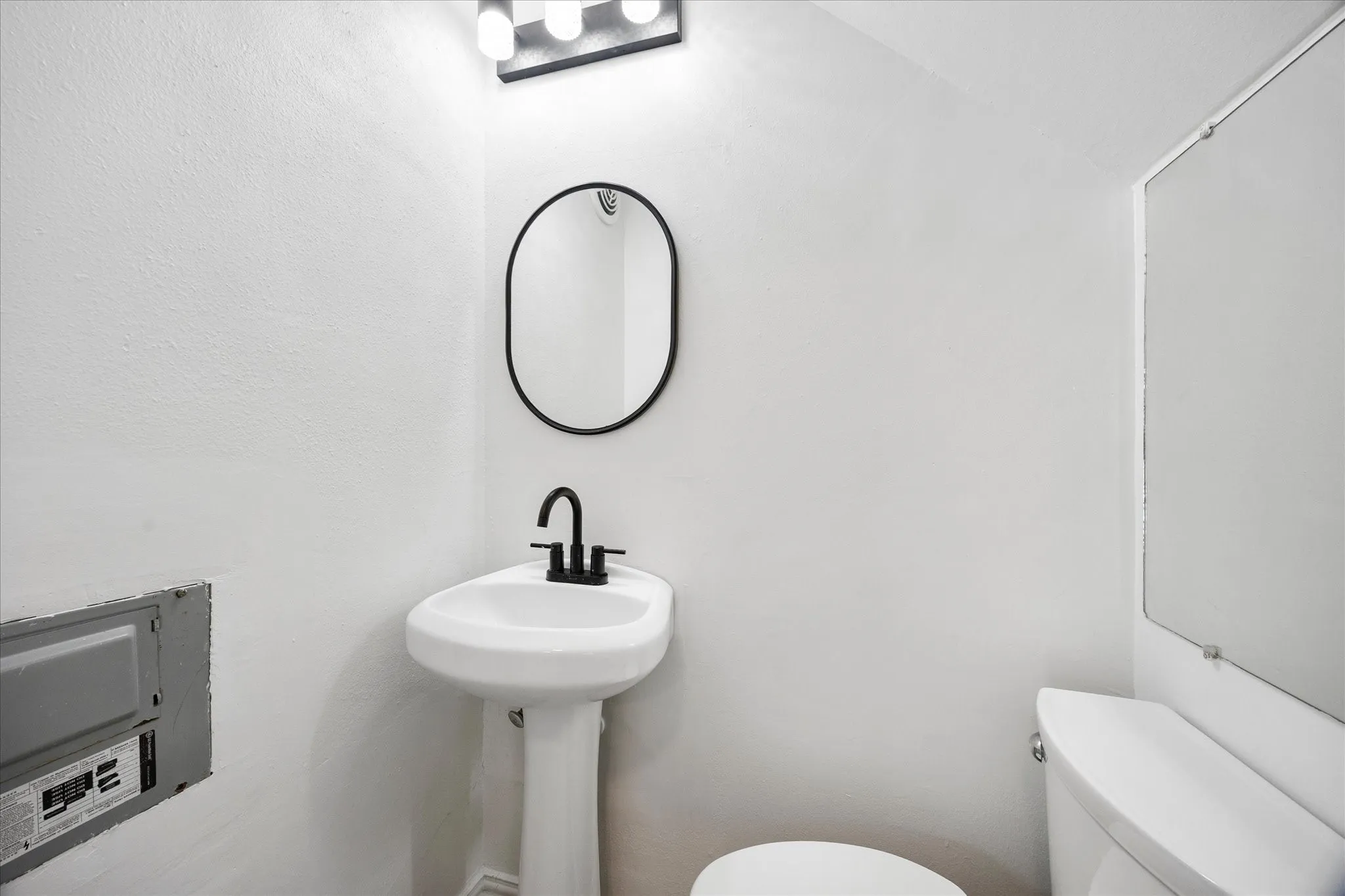 Original updated half bath with pedestal sink.