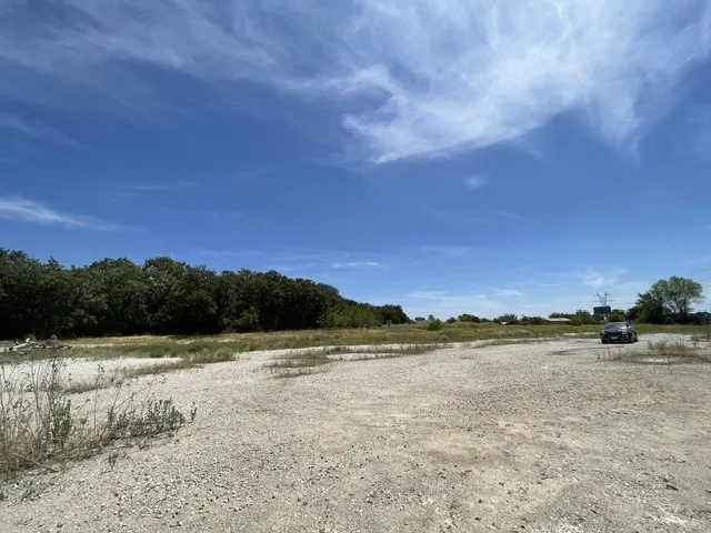 Expansive undeveloped lot with natural tree line and open terrain
