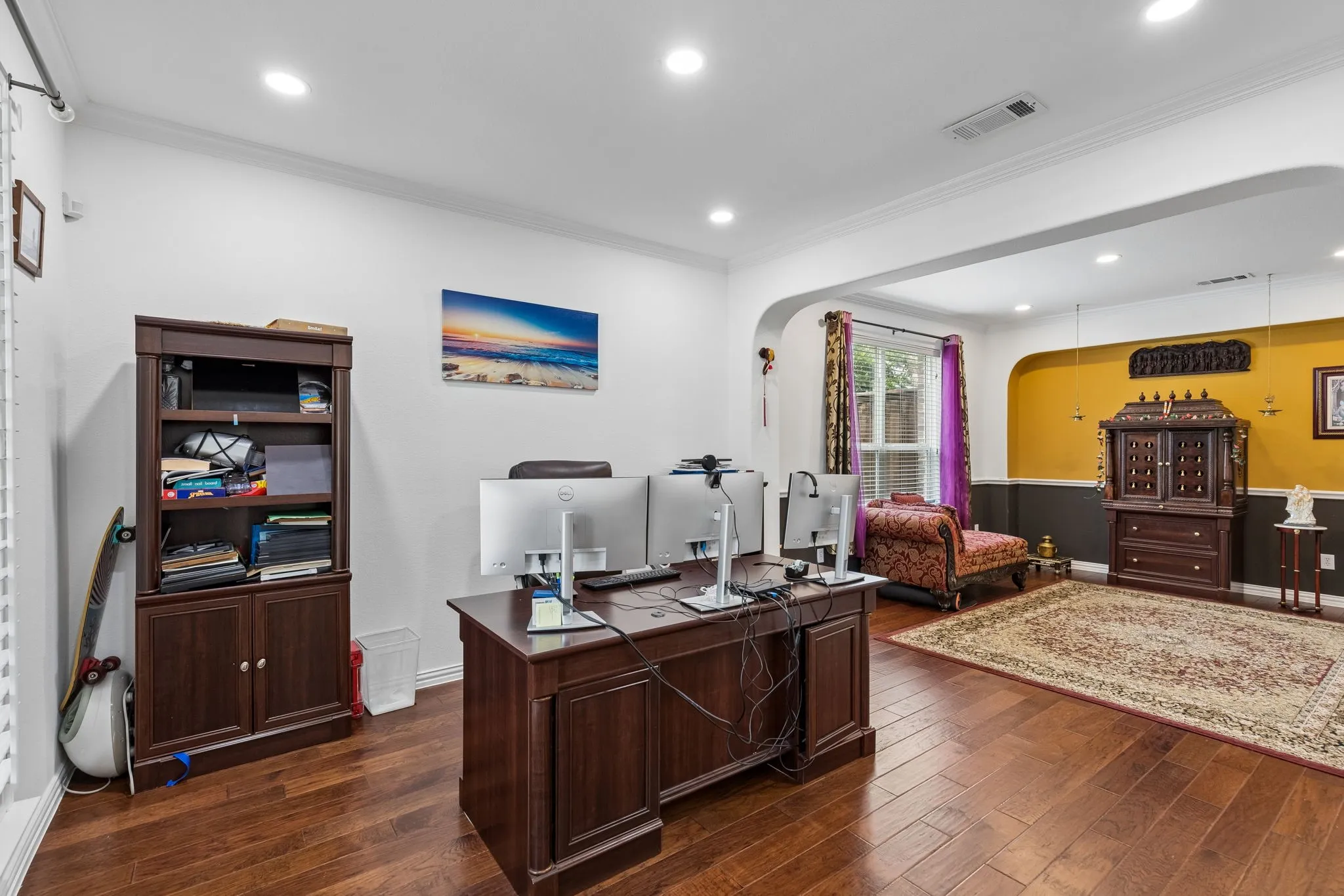 Recessed lighting, crown molding, wood-finish flooring, arched entryway, and built-in cabinetry