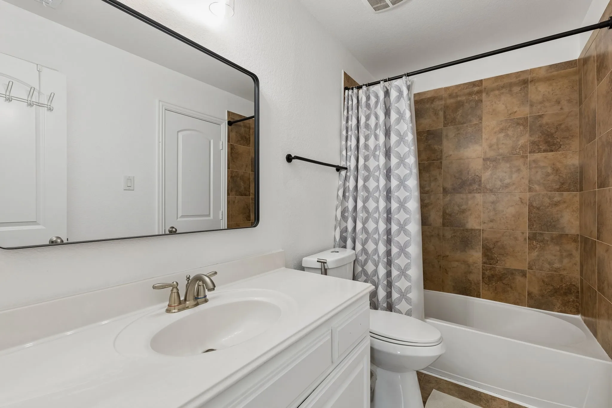White vanity with an integrated sink and brushed nickel faucet