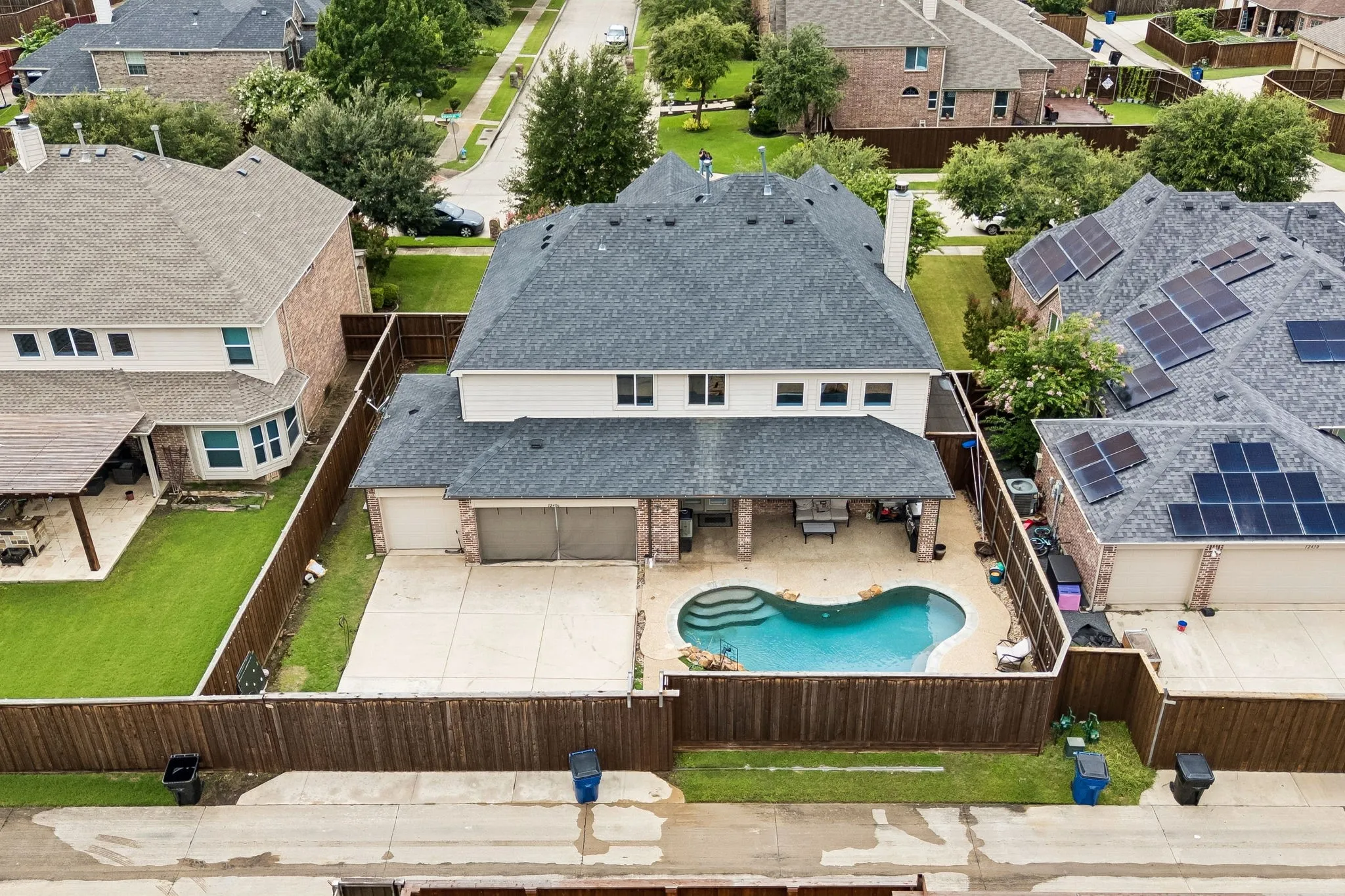 In-ground swimming pool, covered patio, attached garage, fenced yard, and shingle roof