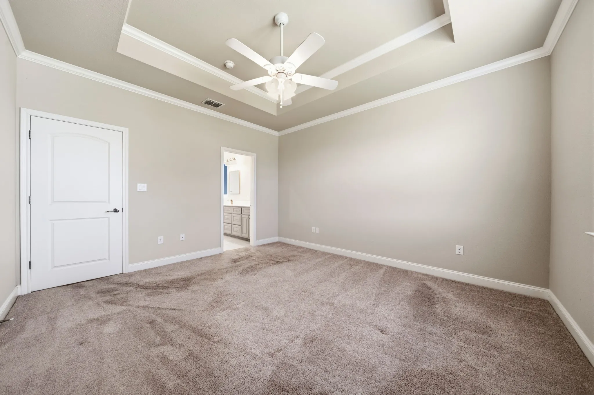 Primary Suite bedroom  with tray ceiling