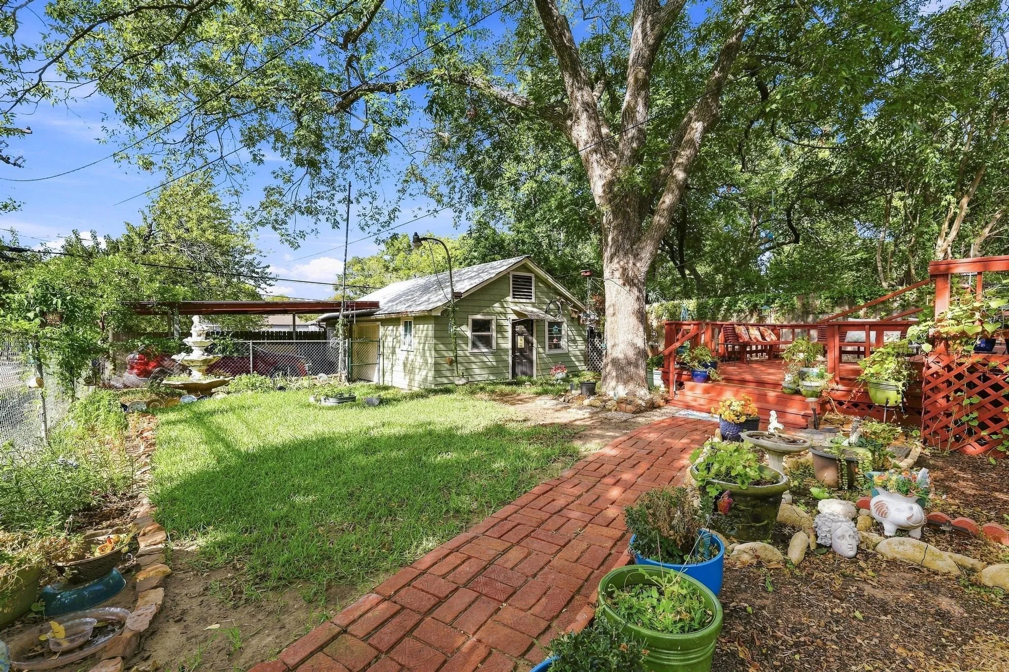 large yard with established landscaping, mature trees and privacy fence