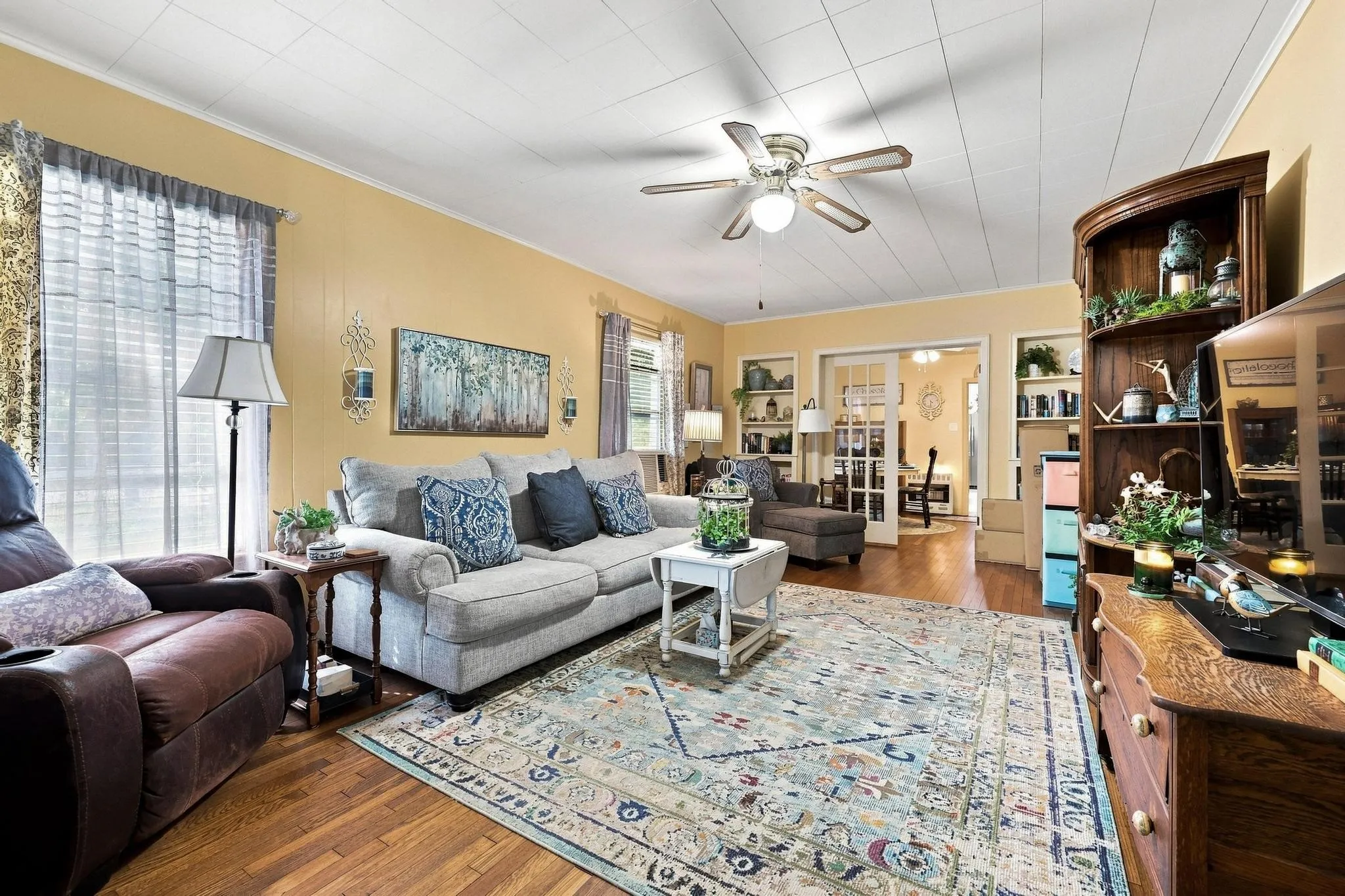 large living room with built ins and plenty of windows
