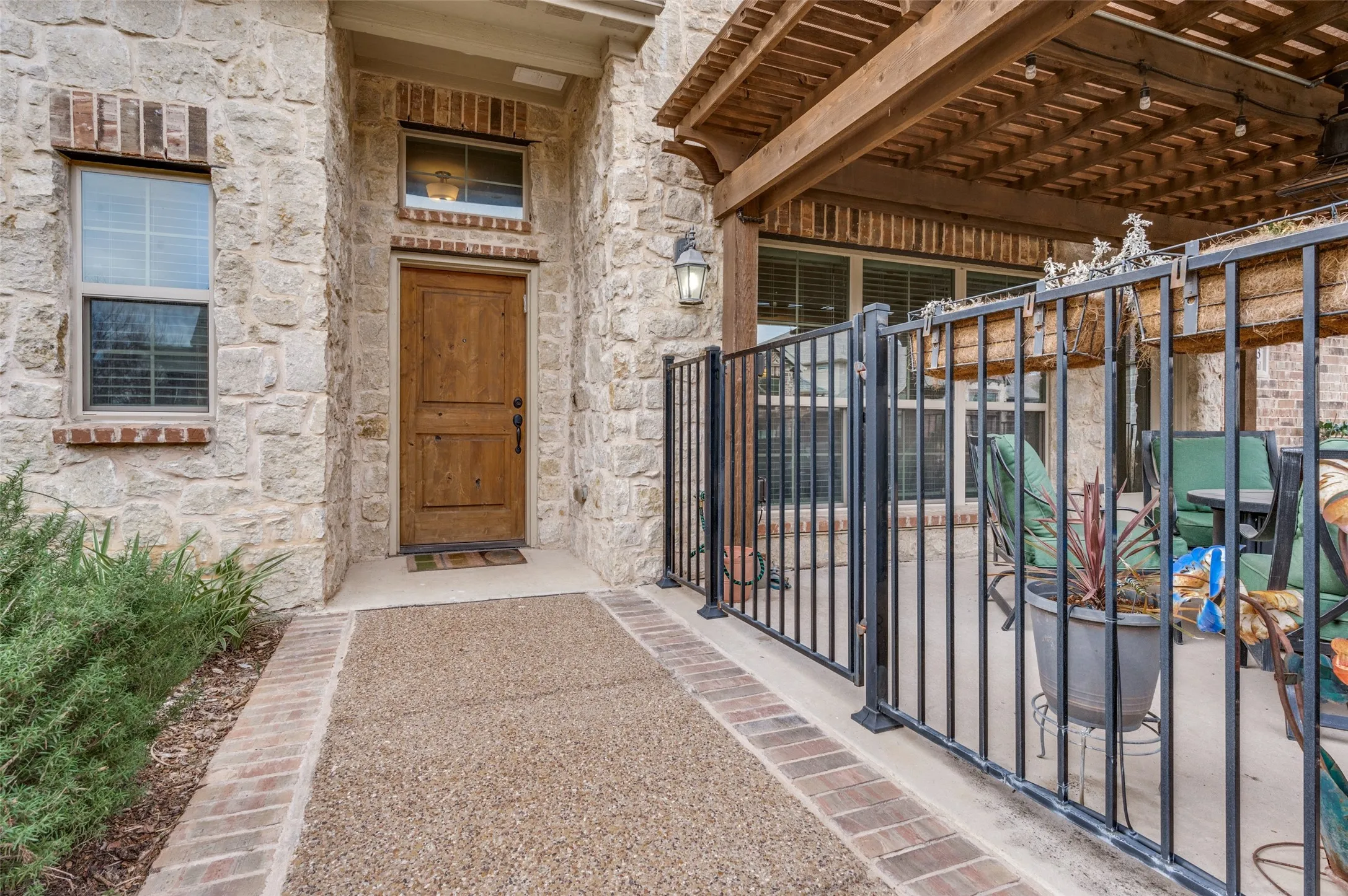 Stone facade with brick accents and a natural wood-finish front door