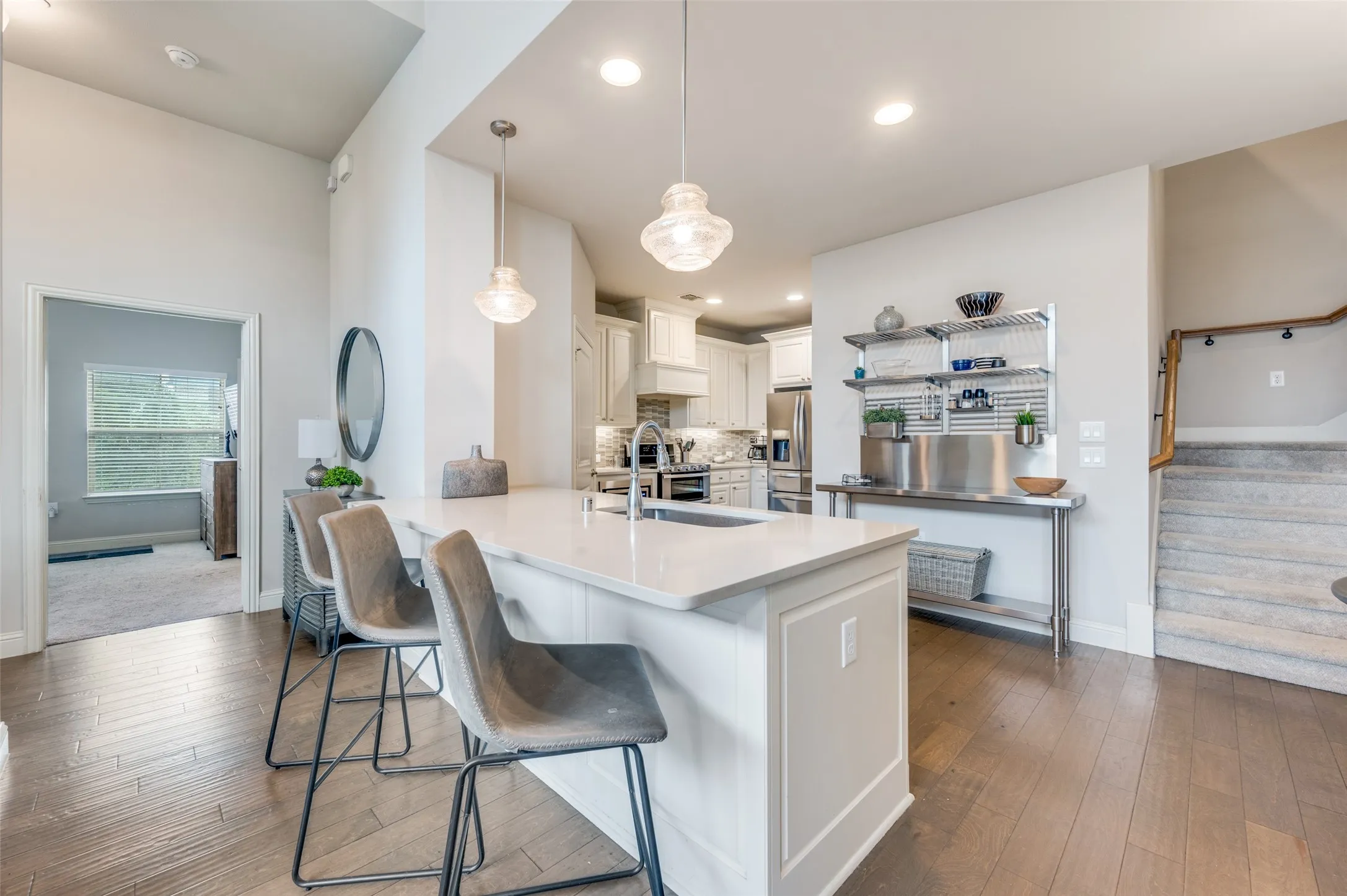 Kitchen island with a built-in sink and pendant lighting