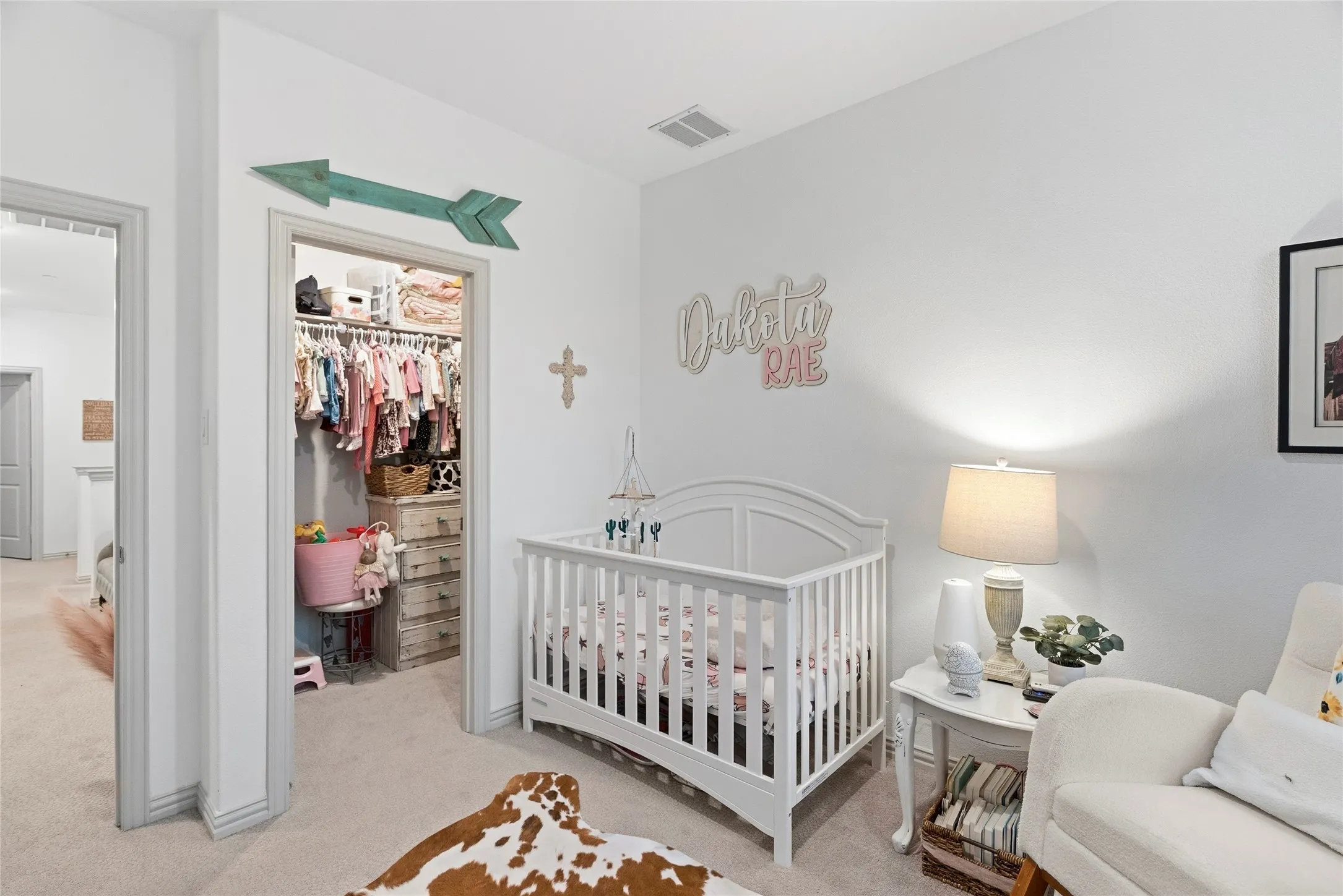 Recessed closet with built-in shelving, neutral wall color, and carpeted flooring