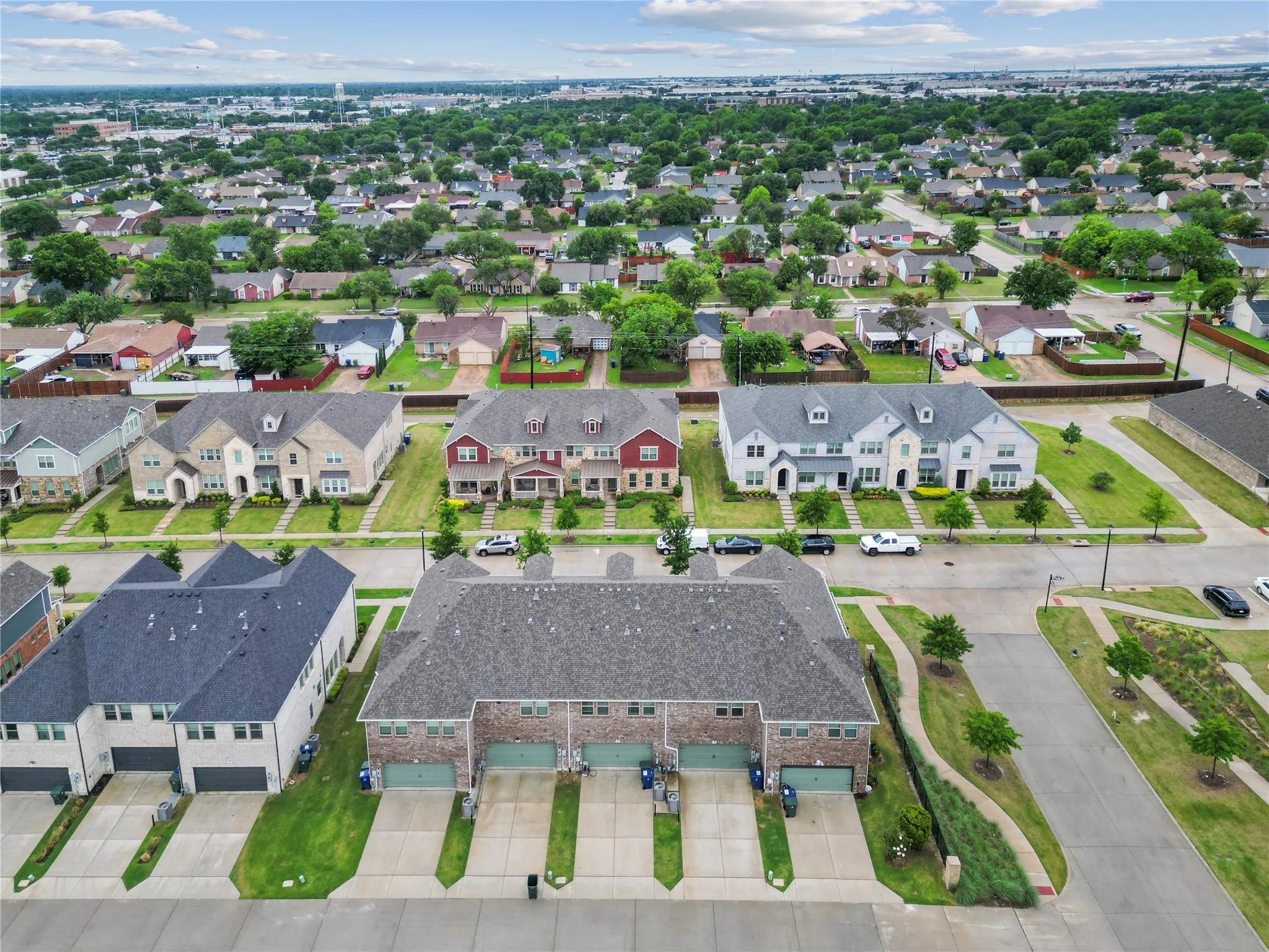 Expansive neighborhood featuring mature trees, uniform residential architecture, a consistent street layout, and multiple housing styles