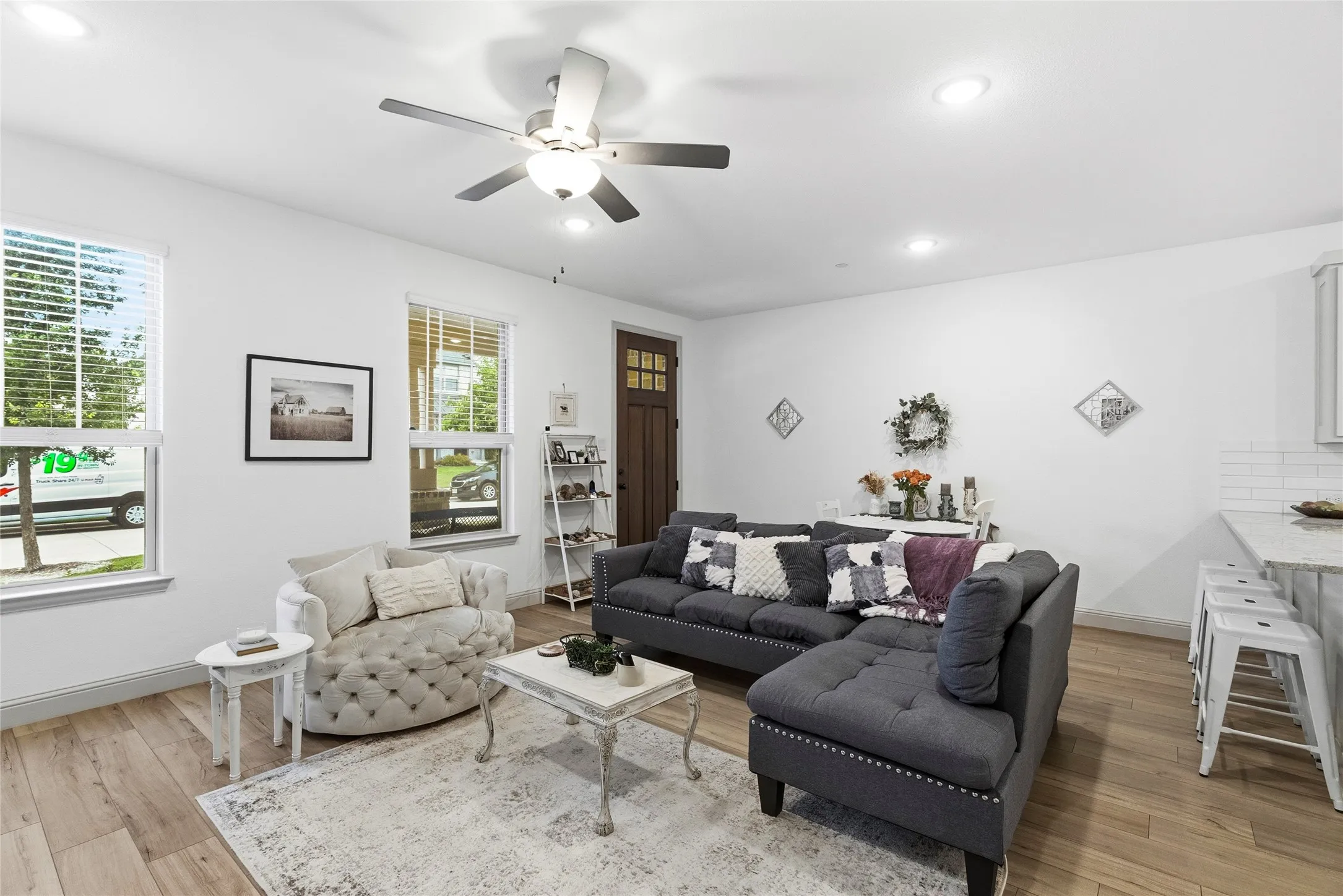Wood-finish flooring, recessed lighting, and a ceiling fan
