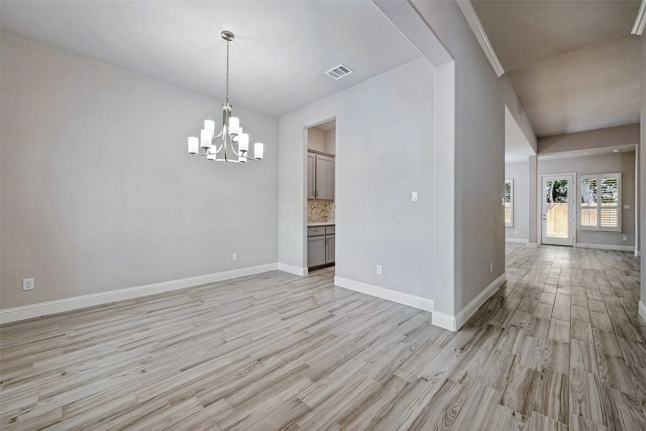Here is another look at the formal dining room which also shows you the adjoining Butlers Pantry. This picture also shows the entry hallway going to the living area.