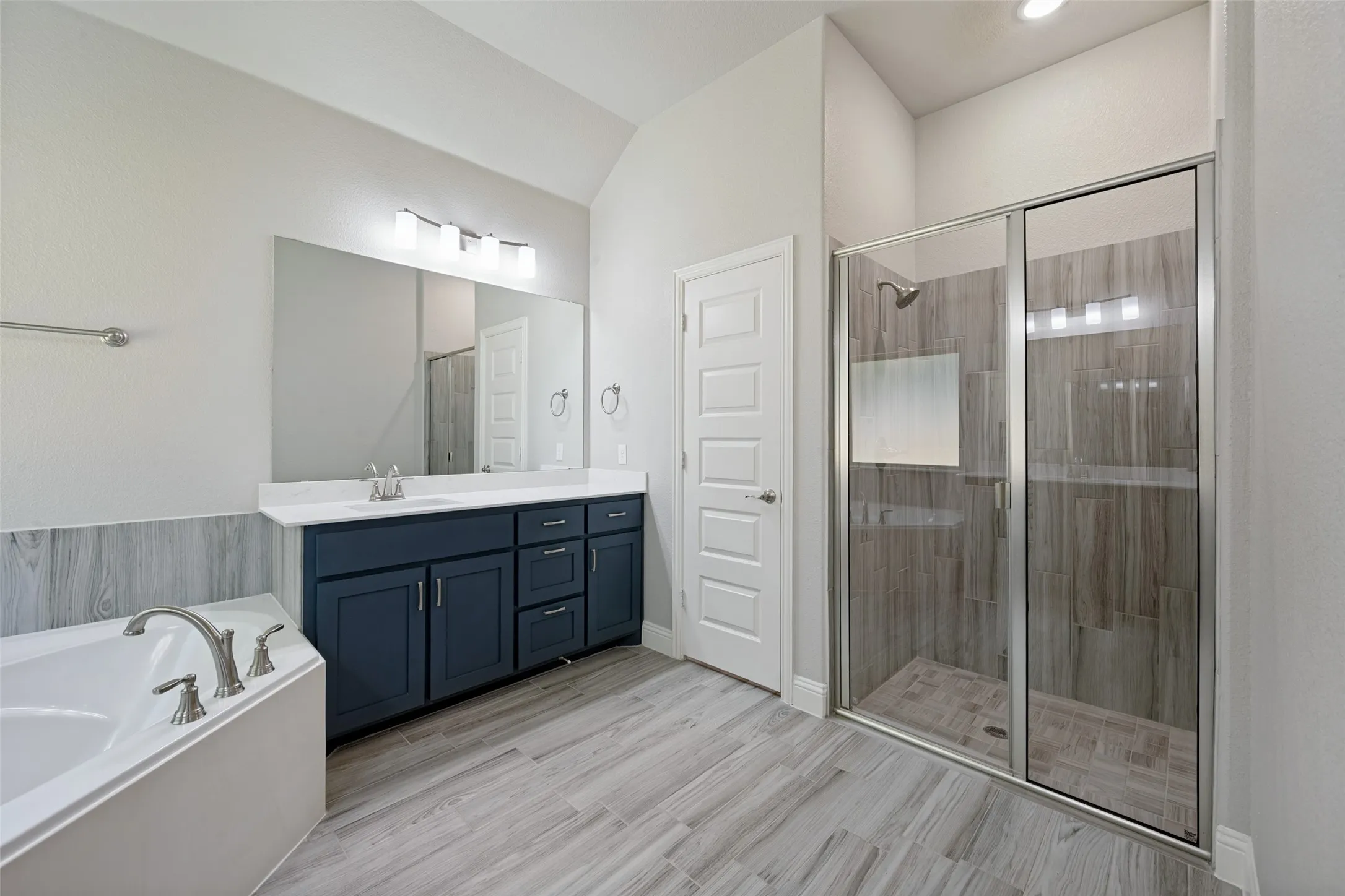 Also included in the bath is a spacious tiled shower.